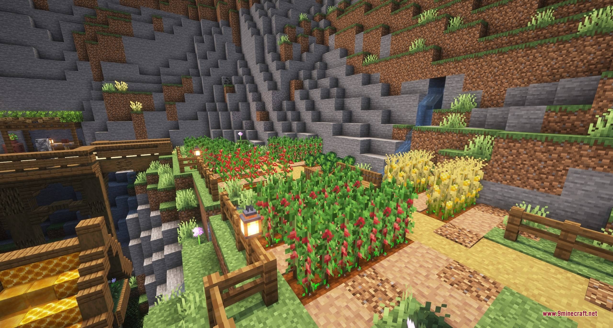 Terraced garden beds with various crops and lanterns built into a stone mountain