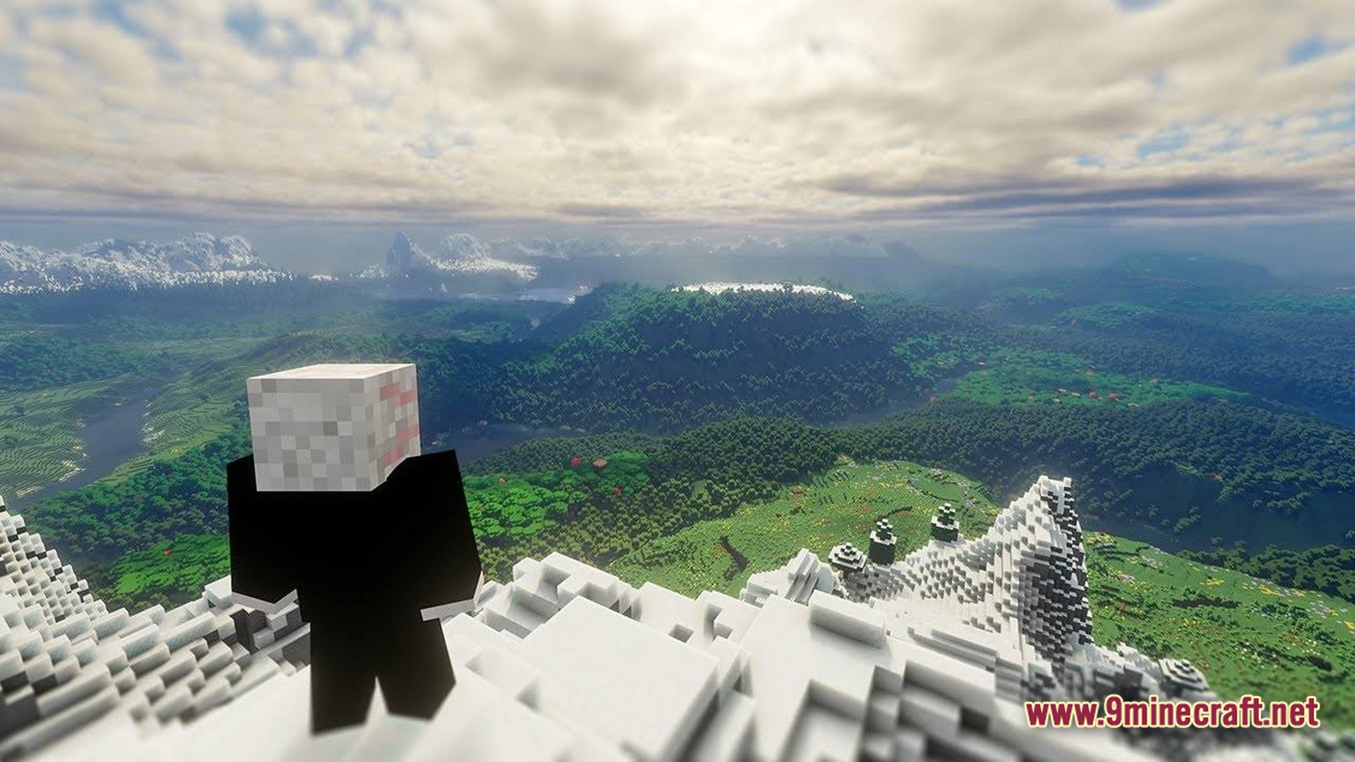 A player character overlooks a vast landscape of forests and mountains with extended render distance