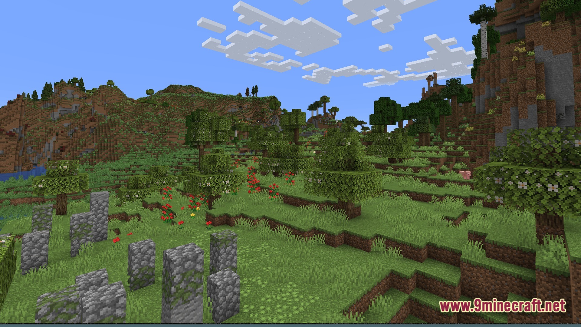 Ff’s Terra Forge Modpack (1.21) – Explore Massive Biomes And Dungeons 9 Mossy cobblestone ruins stand in a grassy meadow surrounded by flowering trees and rolling hills