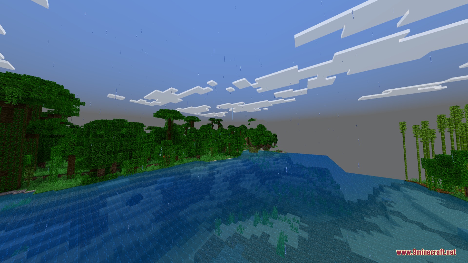 Rain falling over a dense jungle biome next to the water