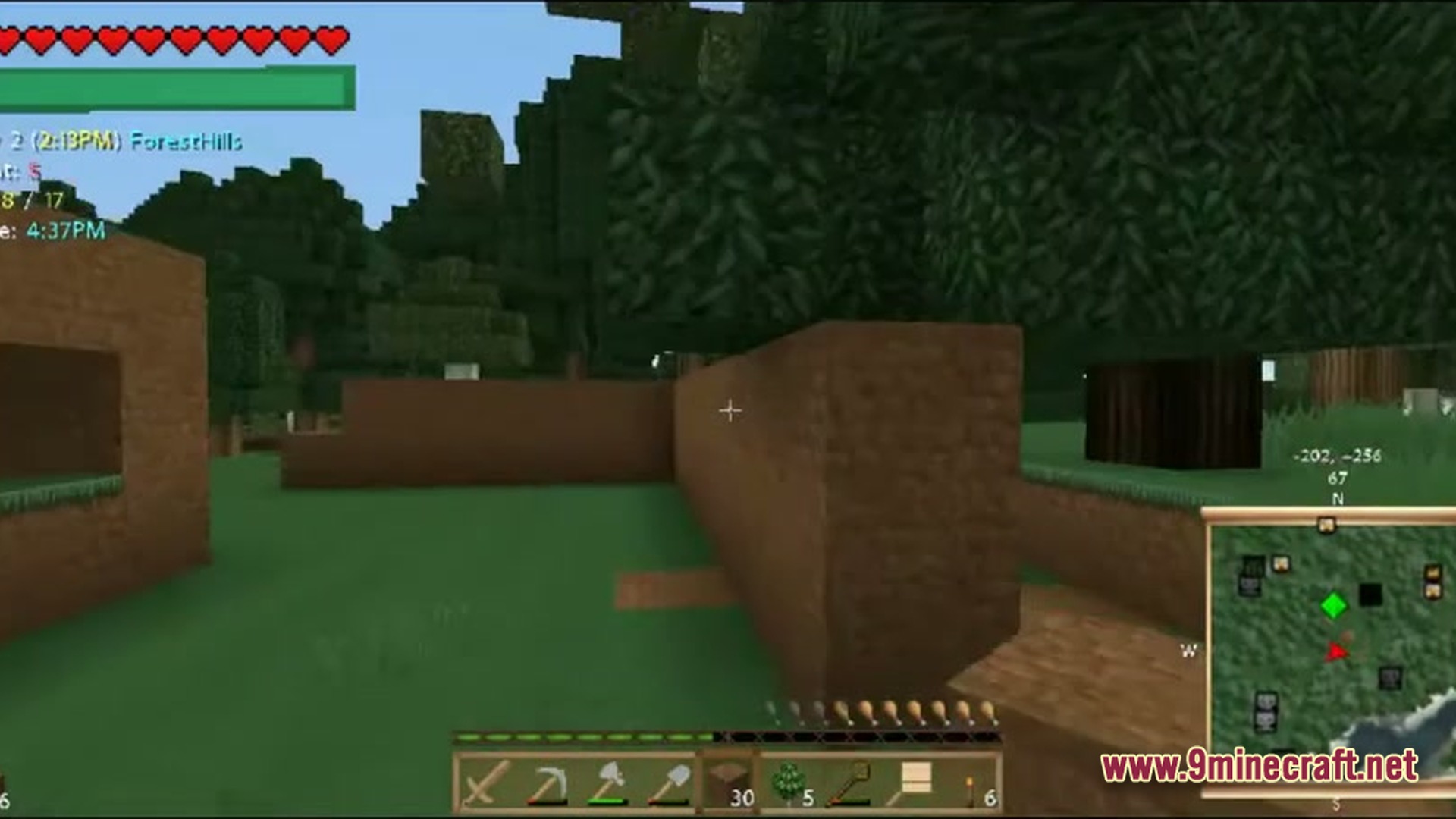 A player builds a dirt structure in a forest biome with a minimap and hud visible