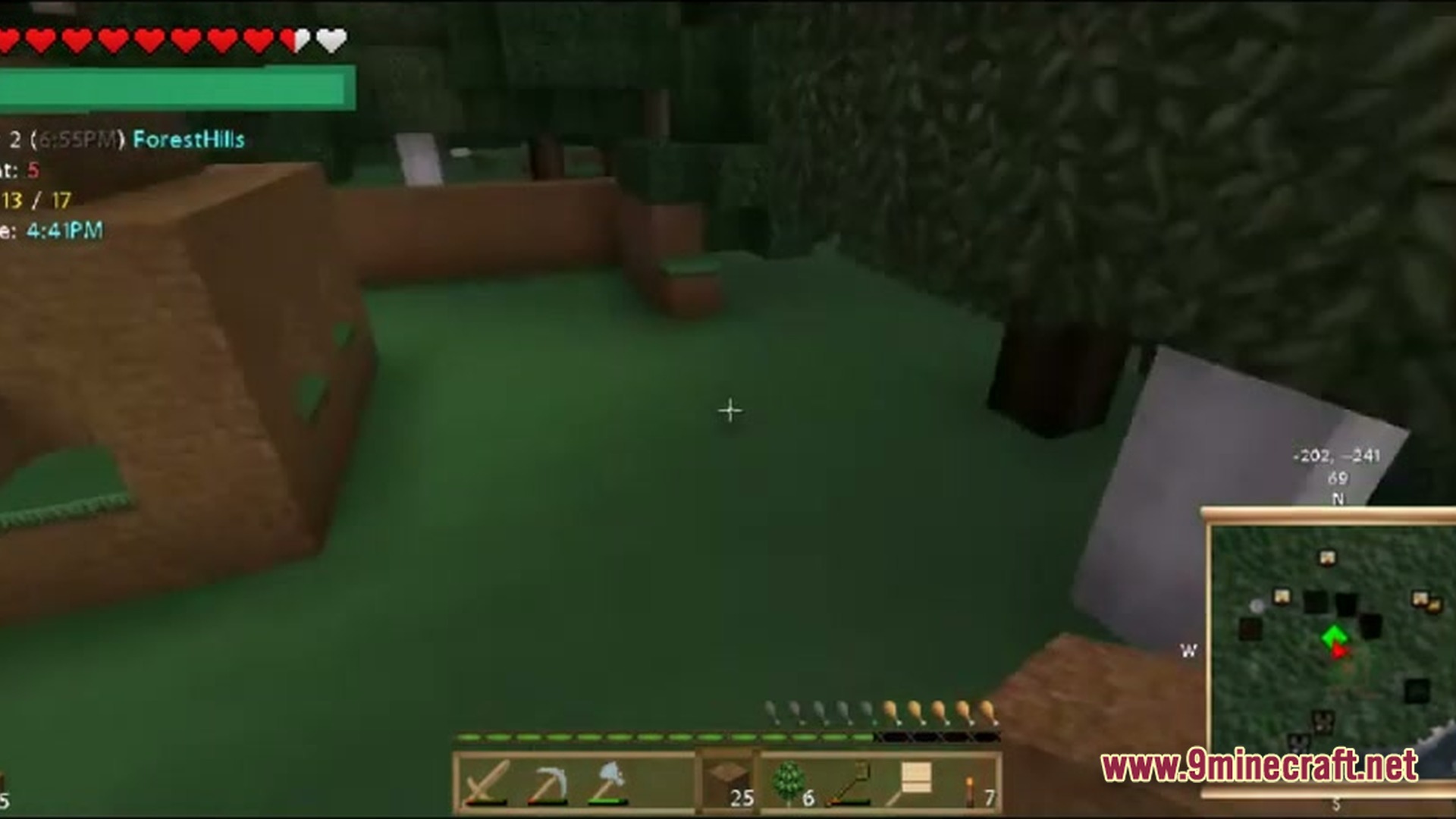 A first-person view of a player standing in a forest biome with a minimap and hotbar