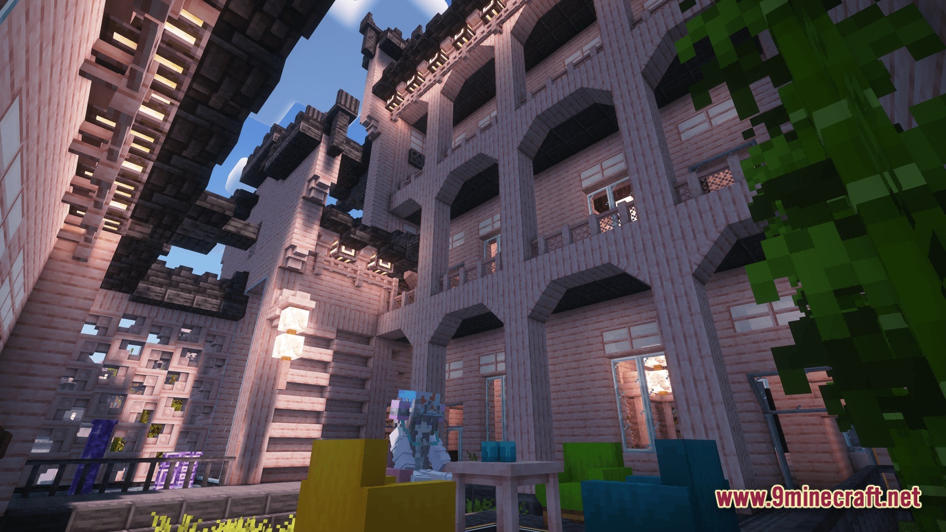 Industrial Banquet Crucible Modpack (1.20.1) – Automate Cooking And Gear Technology 10 A multi-story wooden building with arched balconies and colorful furniture in an outdoor courtyard area