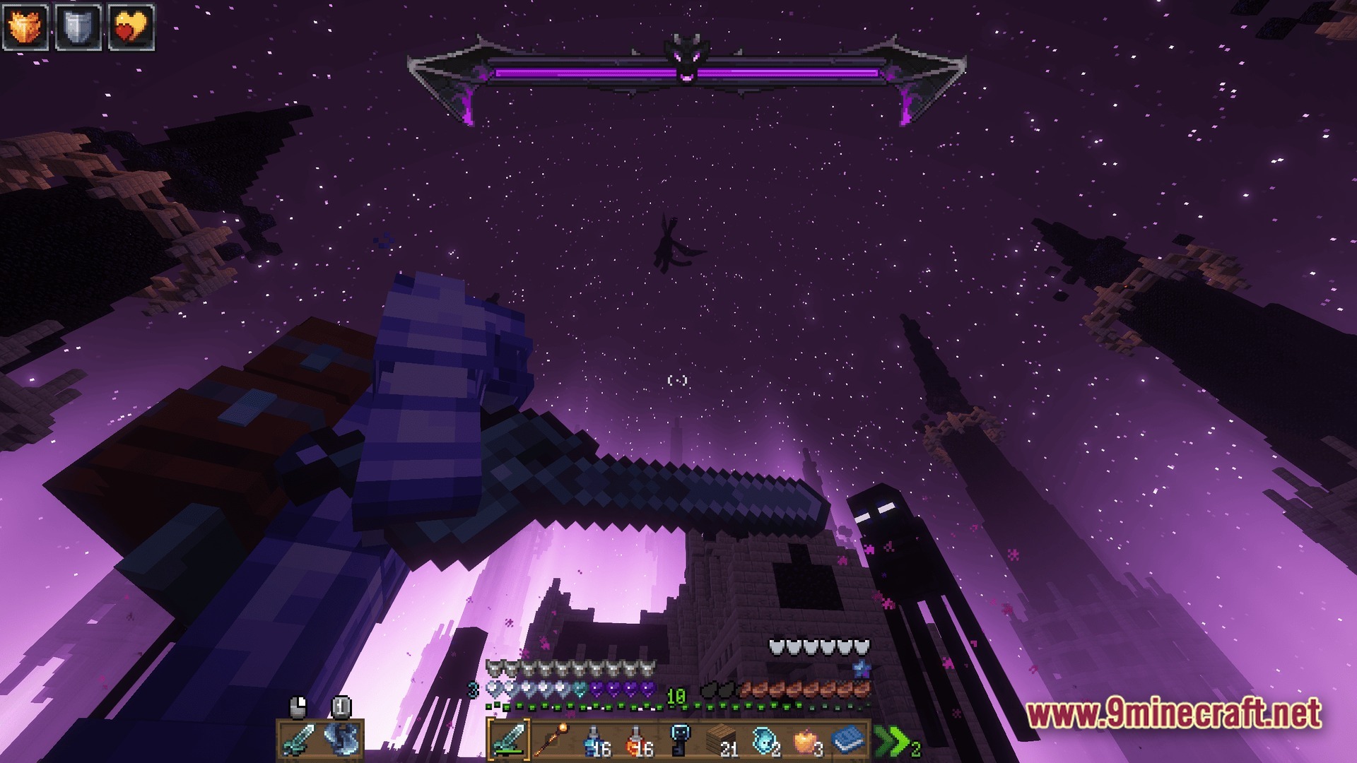 A player fights the ender dragon and endermen among tall obsidian towers in the end