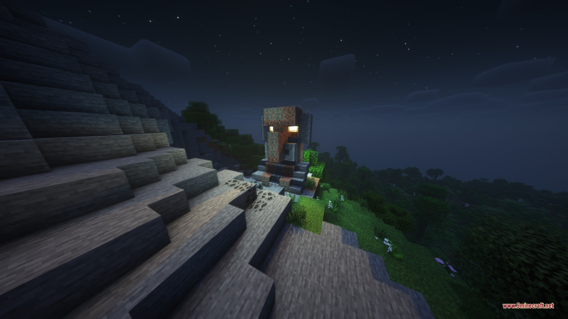 Massive stone villager statue with glowing eyes overlooking a forest at night