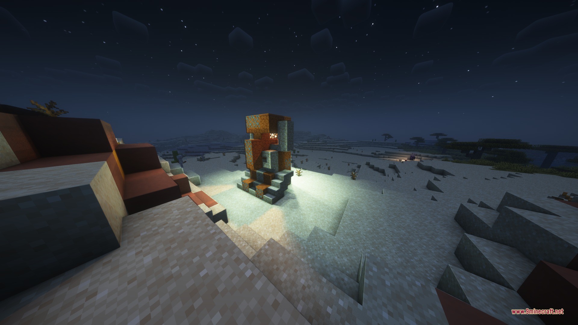 A giant villager statue made of orange blocks in a desert biome at night