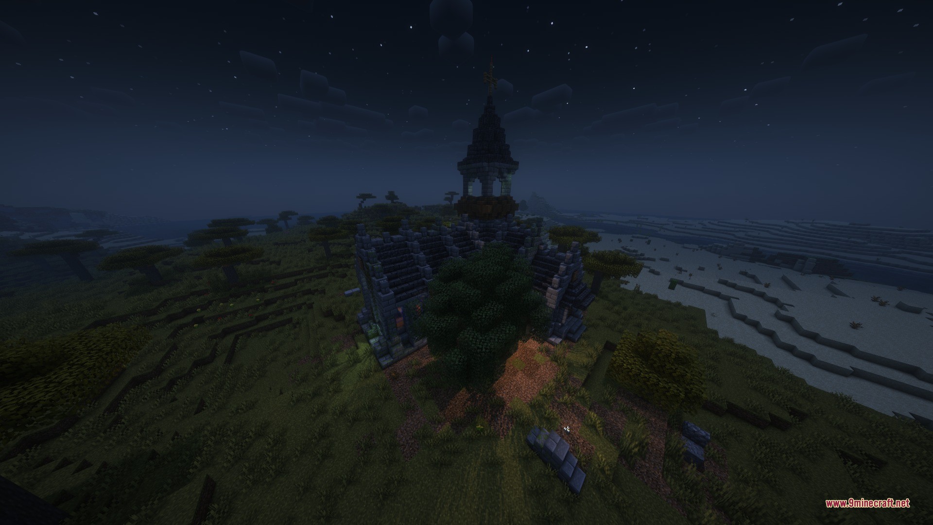 A stone chapel with a tall steeple stands in a savanna biome at night