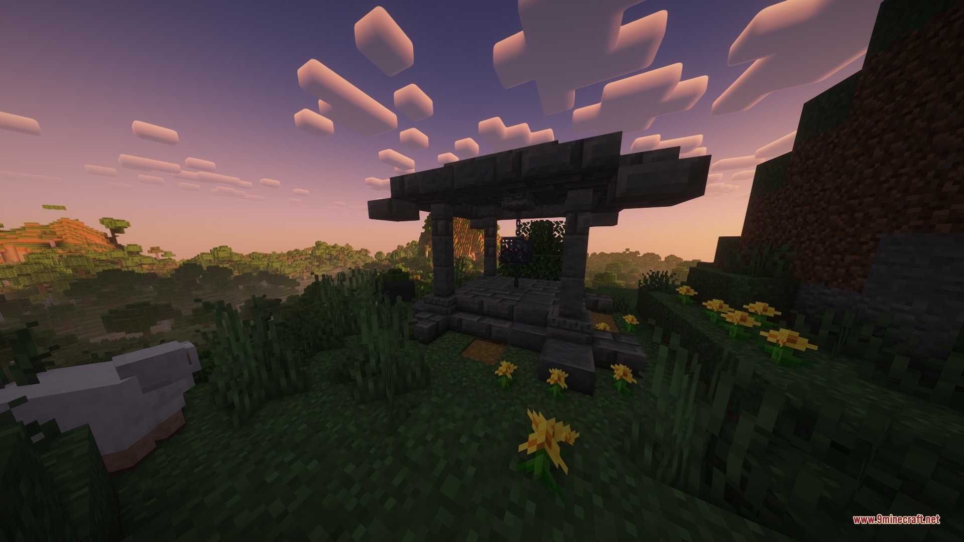 A stone structure from katters structures stands on a hill at sunset