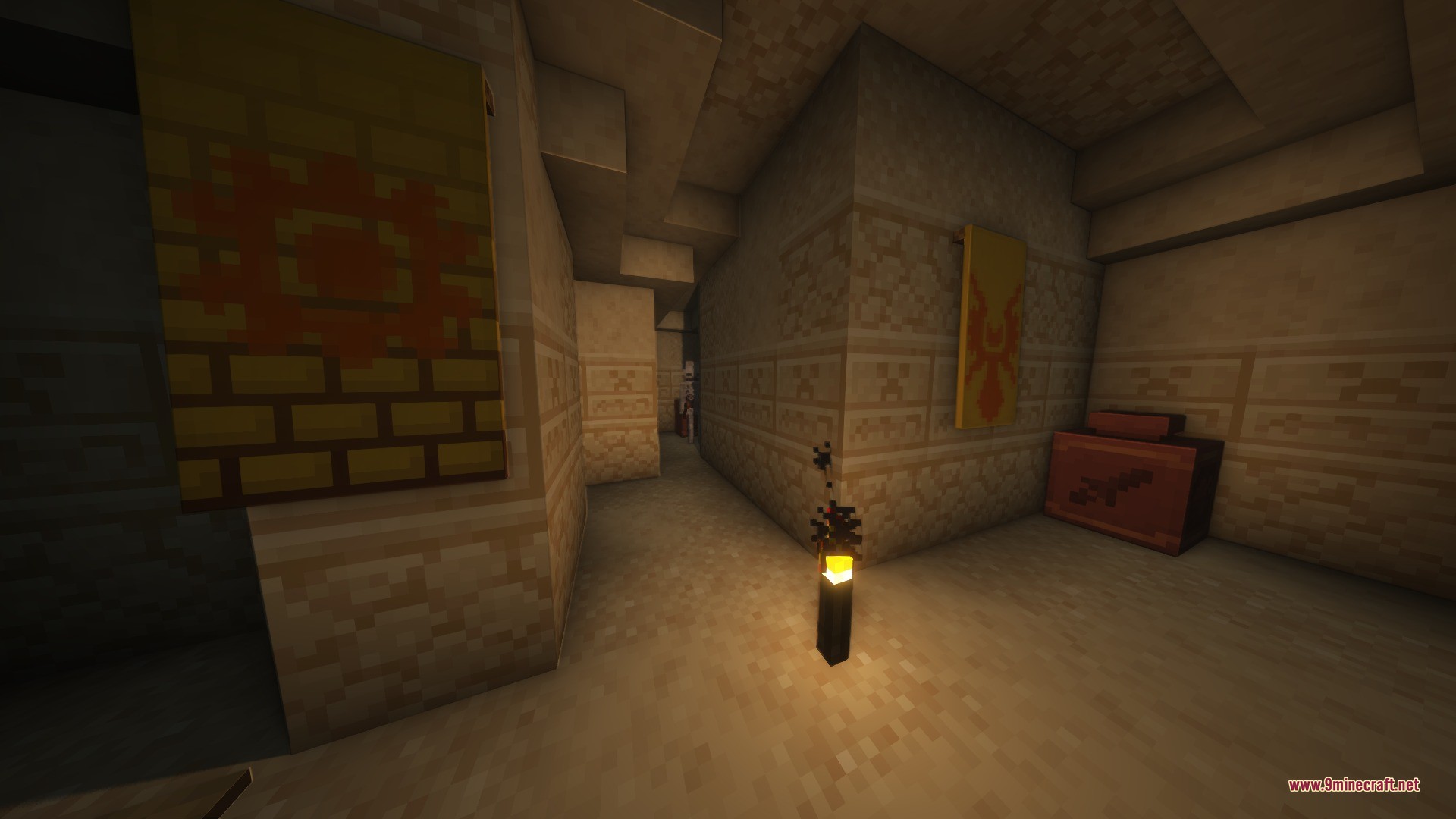 A dark desert dungeon interior featuring sandstone walls and decorative yellow wall banners