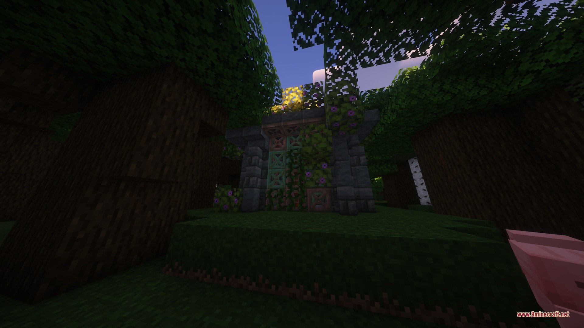 A small stone shrine covered in vines and flowers in a dark forest