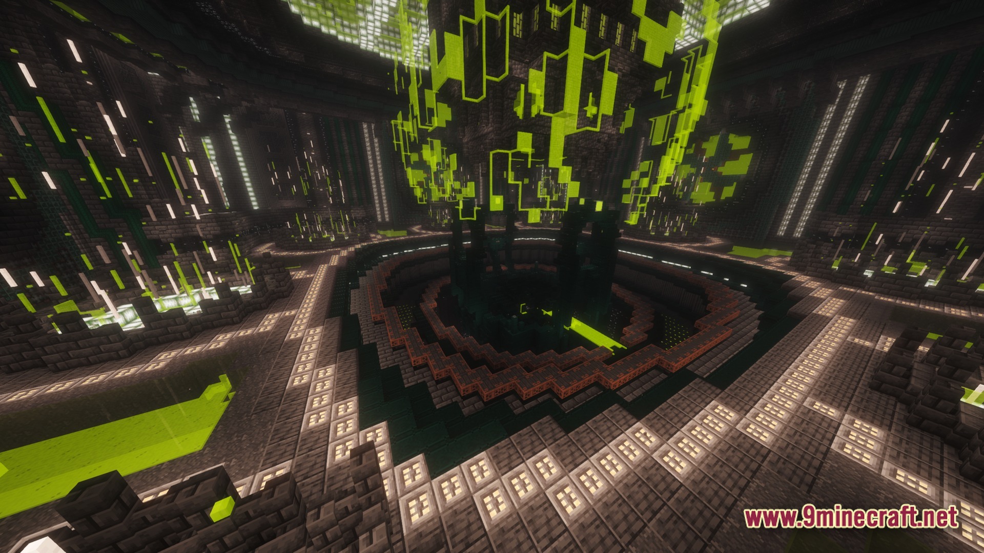 A large circular chamber featuring a central reactor core with glowing green energy and industrial architecture
