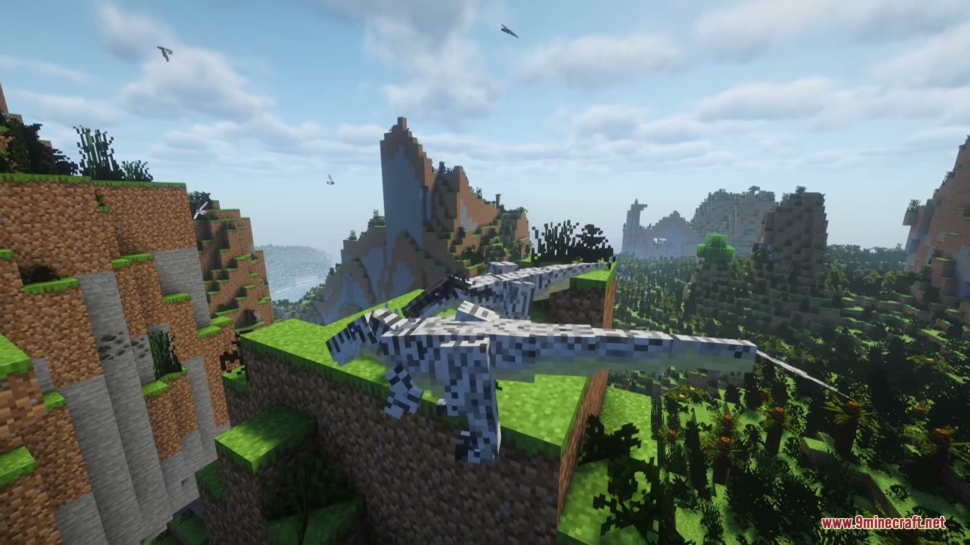 Two white dinosaurs standing on a grassy cliff overlooking a vast valley