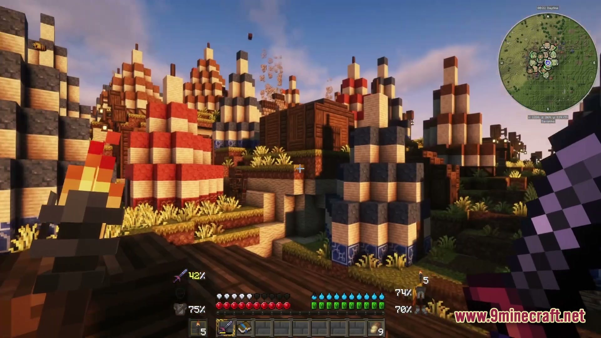 A first-person view of a village with colorful striped tents and wooden buildings in a savanna biome