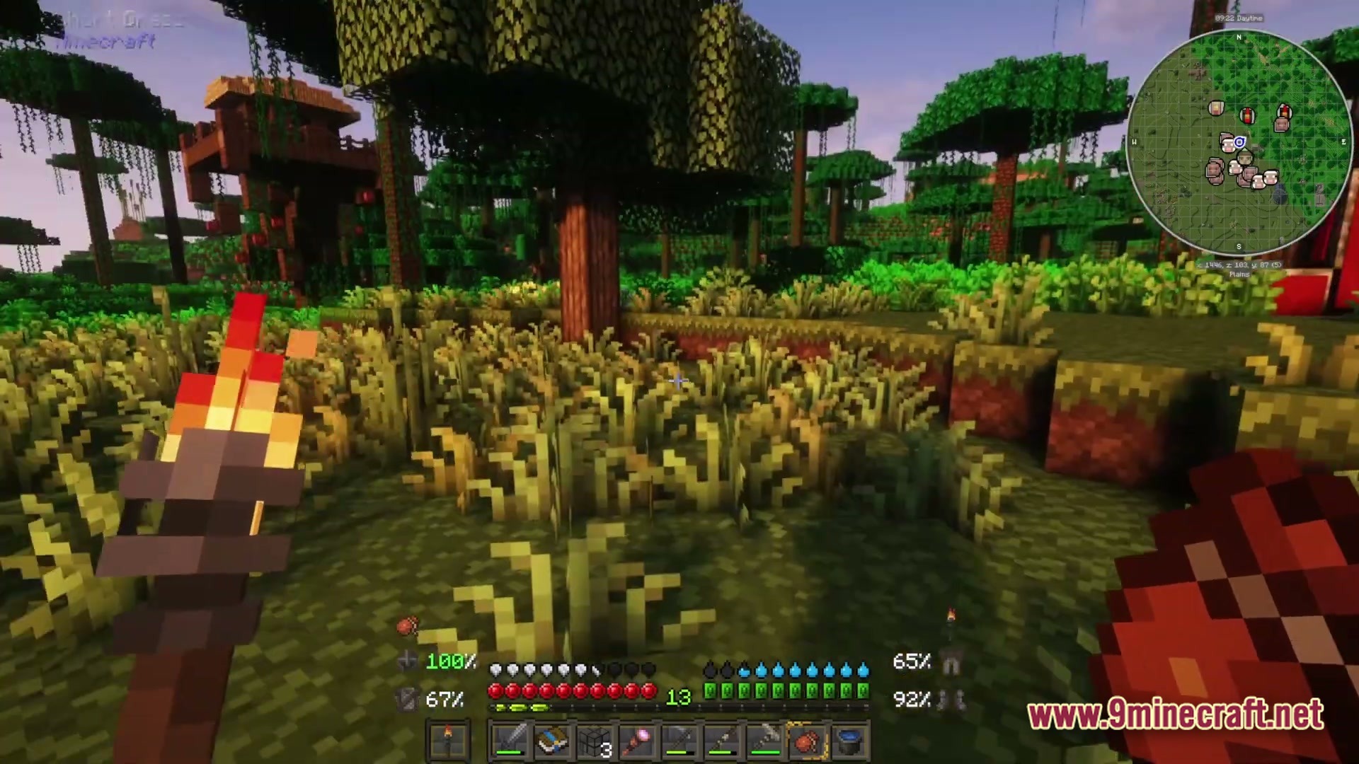 A player holds a torch in a lush jungle biome featuring custom structures and survival hud elements