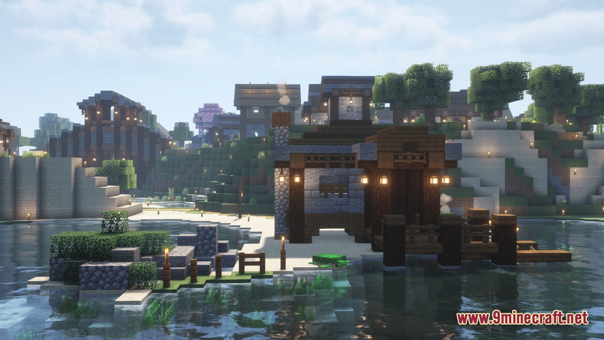 A lakeside village featuring wooden docks, stone buildings, and a sea turtle on a sandy shore