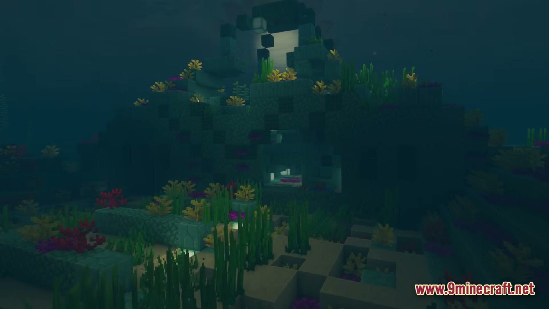An underwater prismarine ruin surrounded by coral reefs and seagrass on the ocean floor