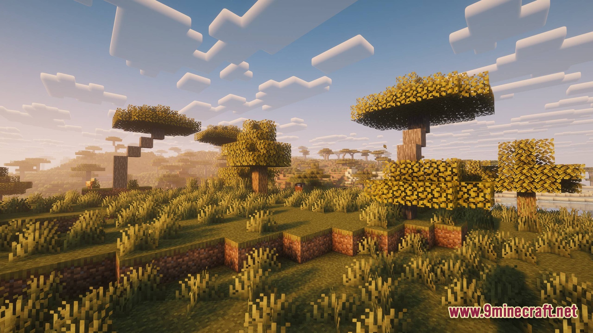 Perennial Core Modpack (26.1.2) – Classic Gameplay With Gentle Upgrades 6 A sprawling savanna biome featuring acacia trees and tall grass under a bright, cloudy sky