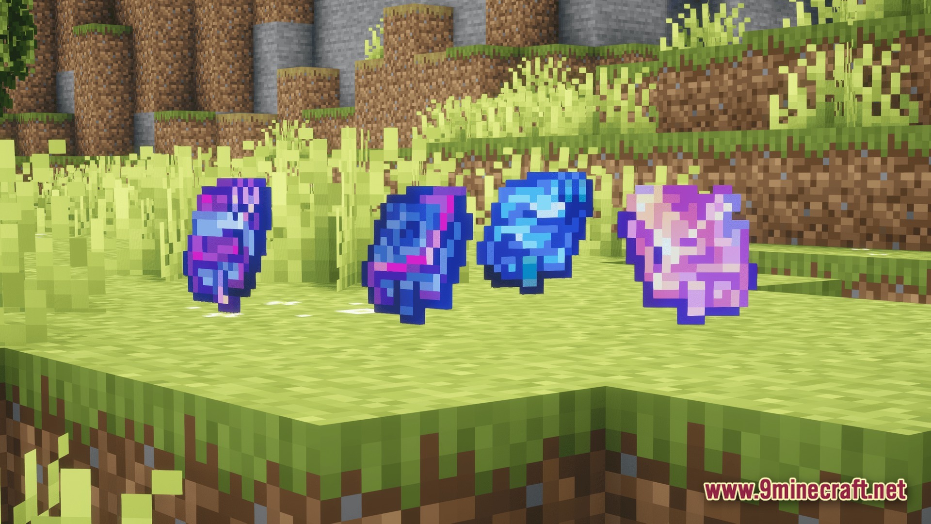 Four colorful magical essence items floating above a grassy field in a minecraft world