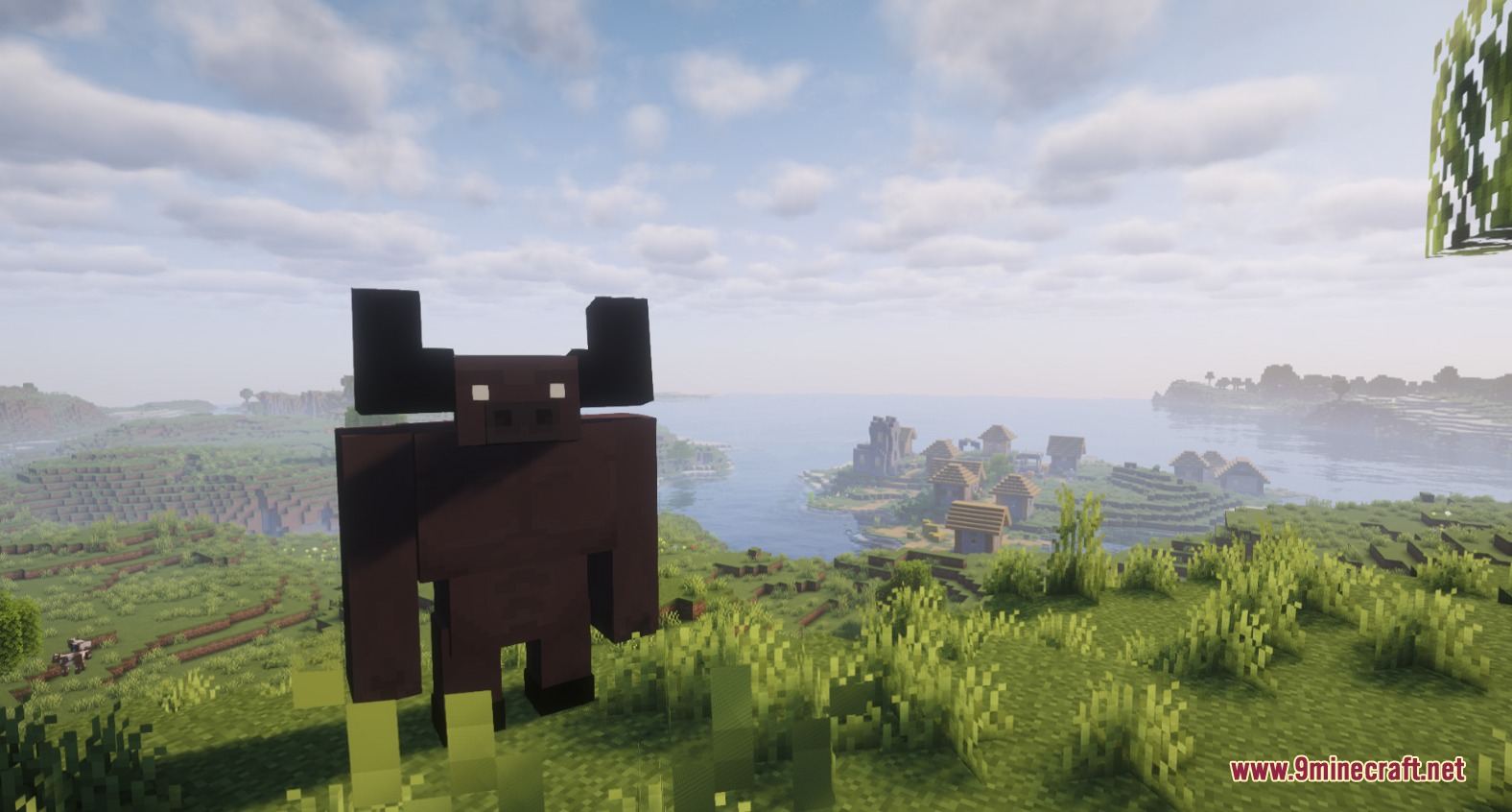 Rpg Adventurer Mod (26.2) – Level Up Your Stats And Cast Spells On Quests 9 A large brown minotaur miniboss standing on a hill overlooking a coastal village
