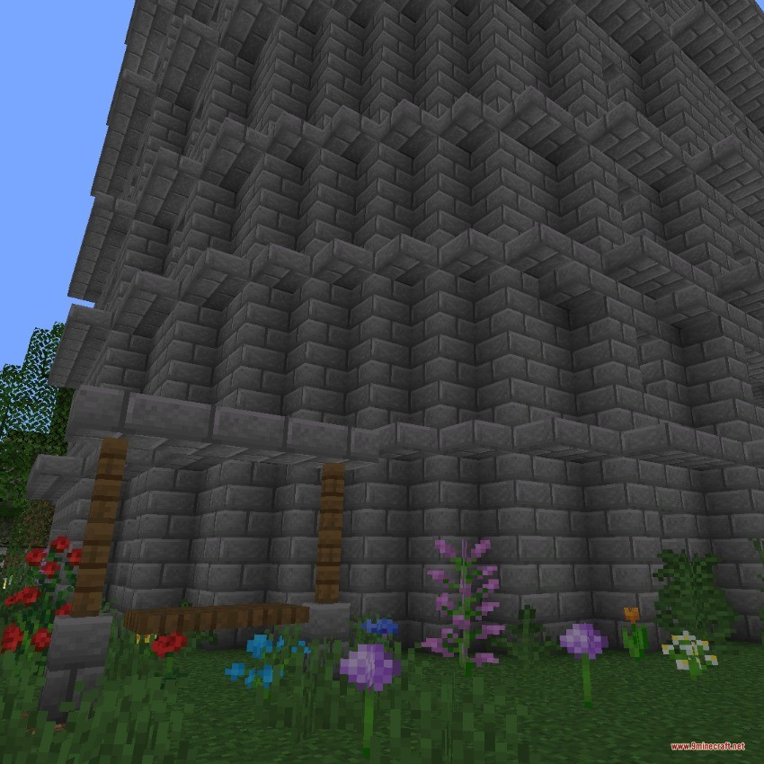 Roguelike Tower Data Pack (1.20.1) – Climb Randomized Floors For Rich Dungeon 5 A tall stone brick tower structure with flowers growing at the base