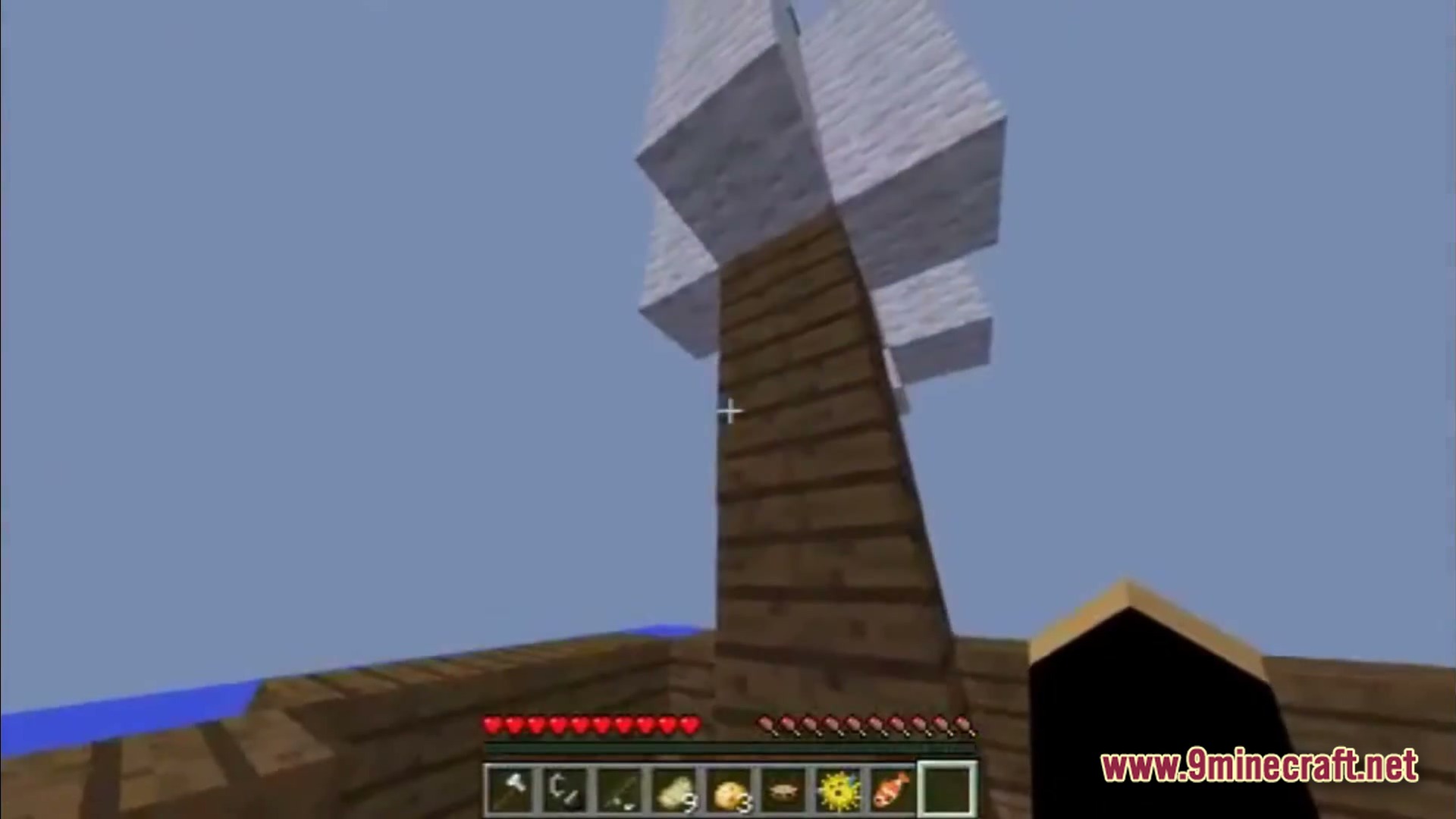 Saltwater Chronicles Modpack (1.21.1) – Explore Oceans And Defeat Monsters 2 A first-person view of a wooden ship mast with white wool sails on the open ocean
