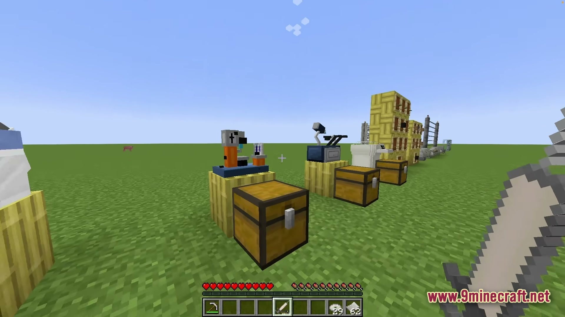 Various laboratory machines and storage chests are placed on a flat grass plain in minecraft