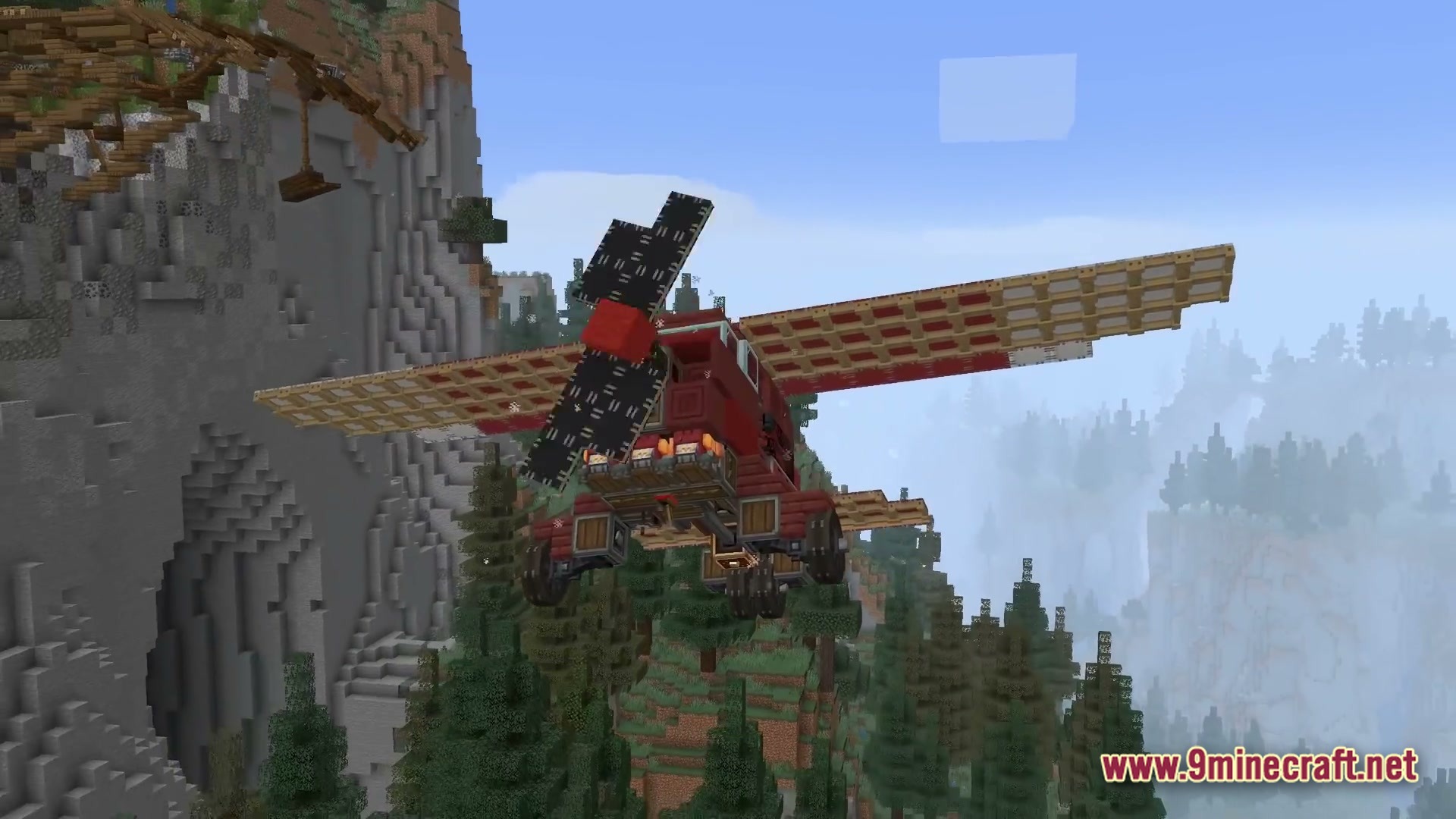 Skybound Engineering Alpha Modpack (1.21.1) – Build And Fly Moving Machines 2 A red propeller airplane flies over a dense evergreen forest near a steep mountain cliff
