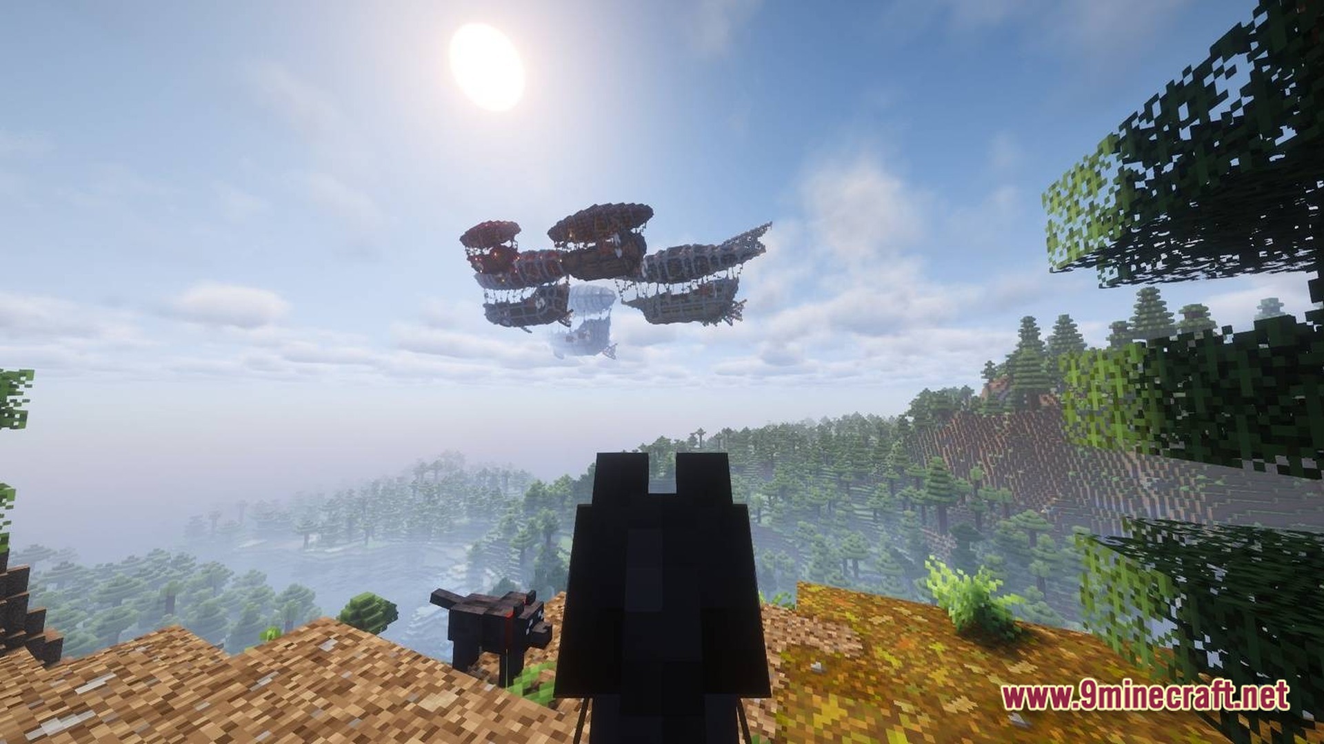 Skybound Engineering Alpha Modpack (1.21.1) – Build And Fly Moving Machines 10 A group of airships flies over a forested mountain landscape under a bright sun