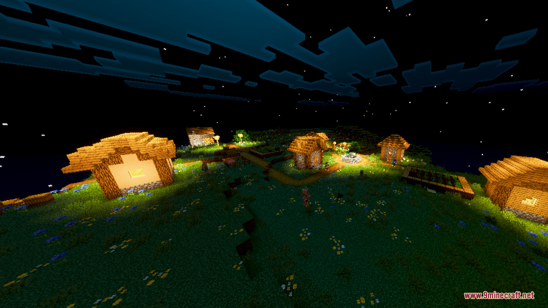 A cozy village glowing with warm light under a starry night sky