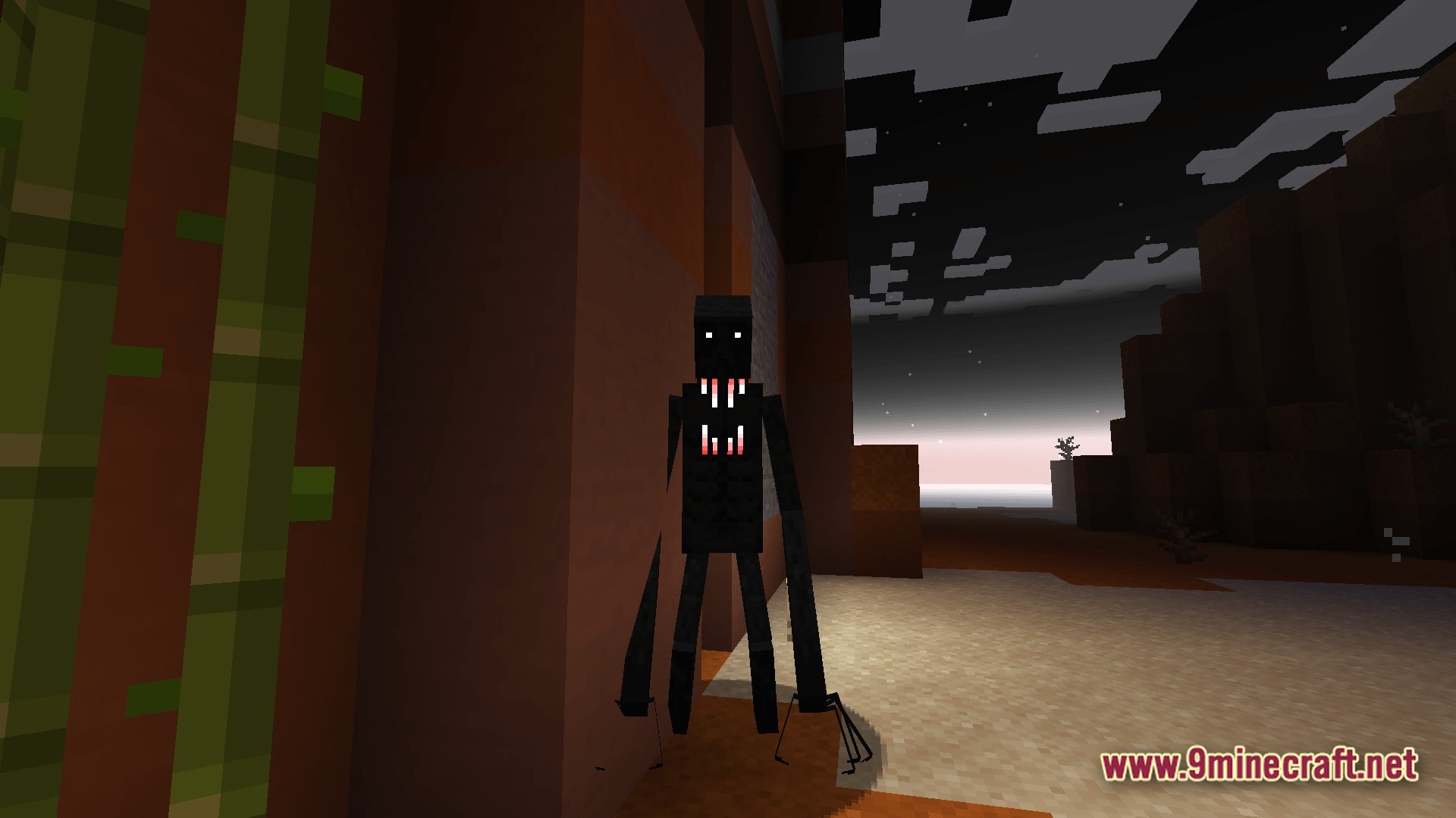 A tall, dark cave dweller entity stands near a mesa cliffside at dusk