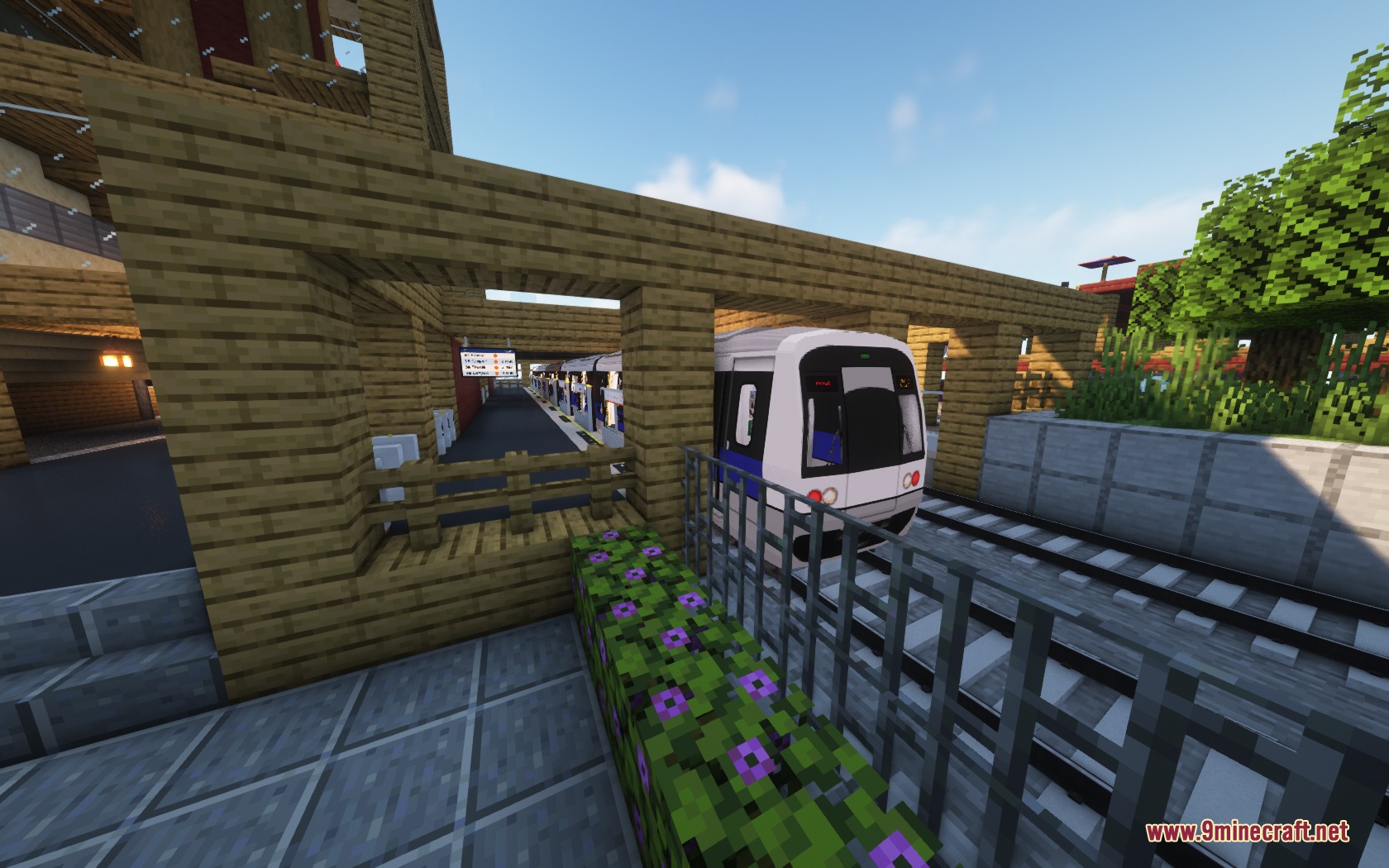 Steel Transit Blueprints Resource Pack (1.20.1) – Sleek Modern Trains 2 A white and blue stb metro train pulls into a wooden station platform