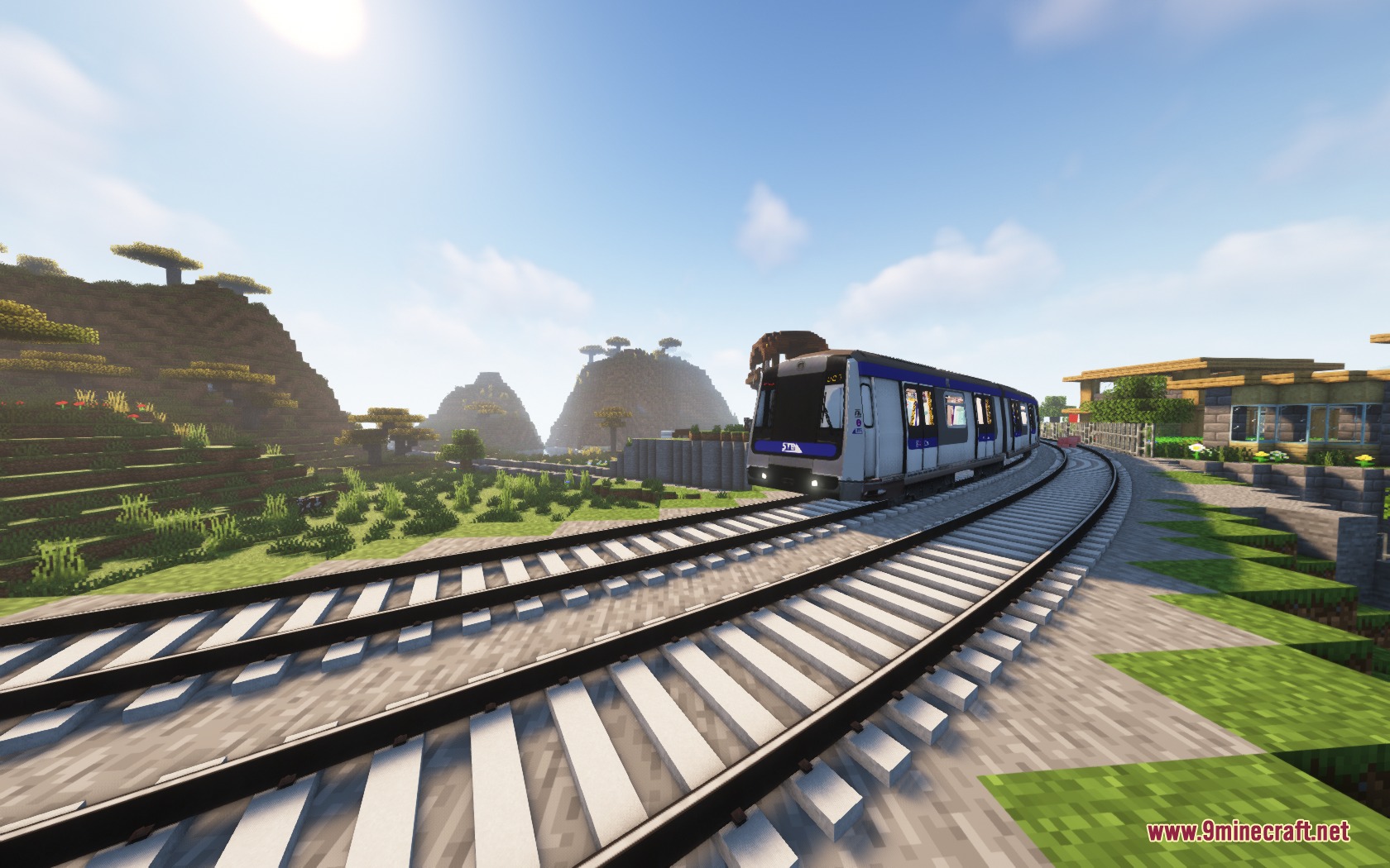 Steel Transit Blueprints Resource Pack (1.20.1) – Sleek Modern Trains 6 A blue and white train traveling on curved tracks through a minecraft savanna