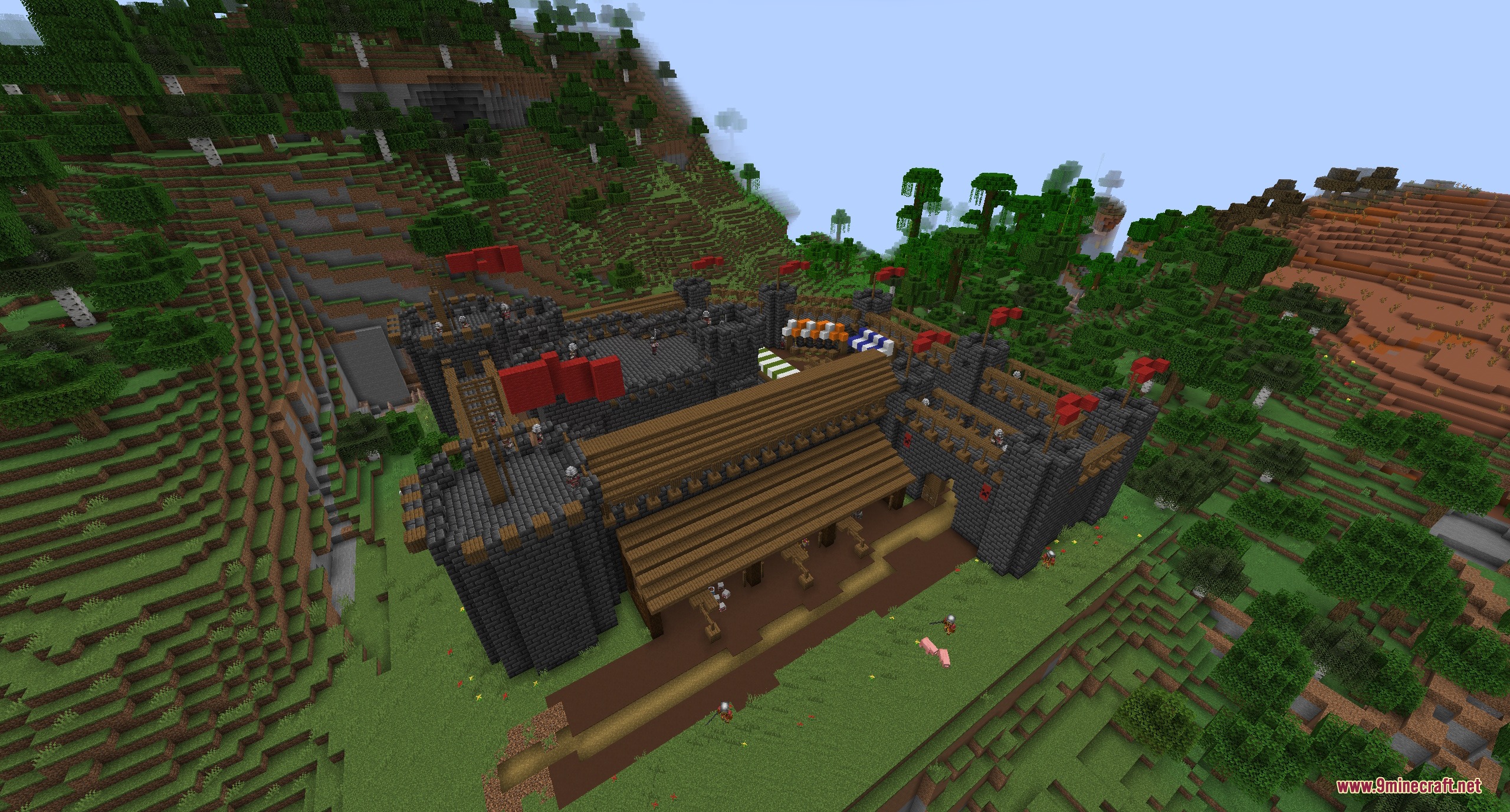 A large medieval stone fortress with red flags and soldiers on guard