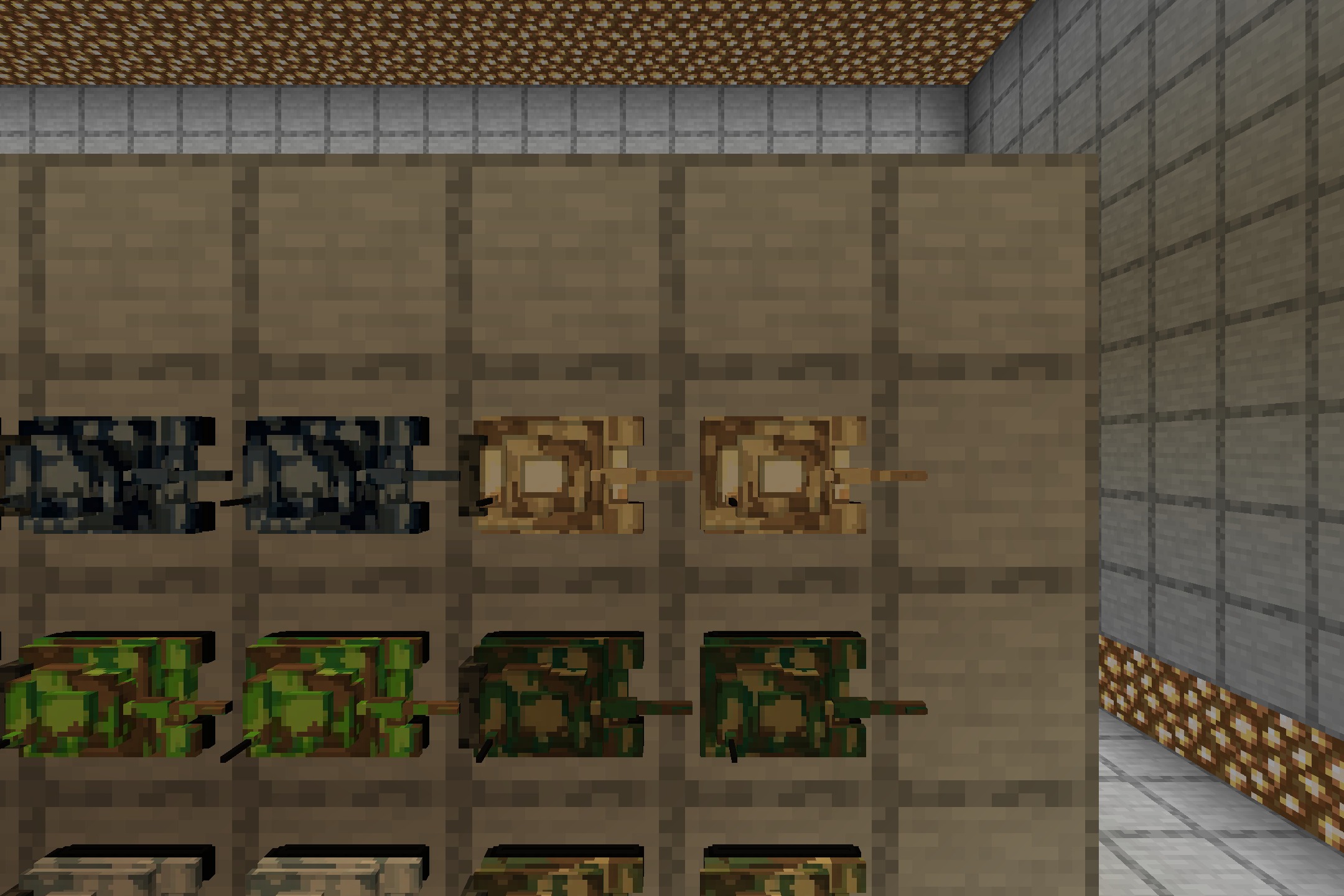 Close up view of desert and forest camouflage tank models in item frames