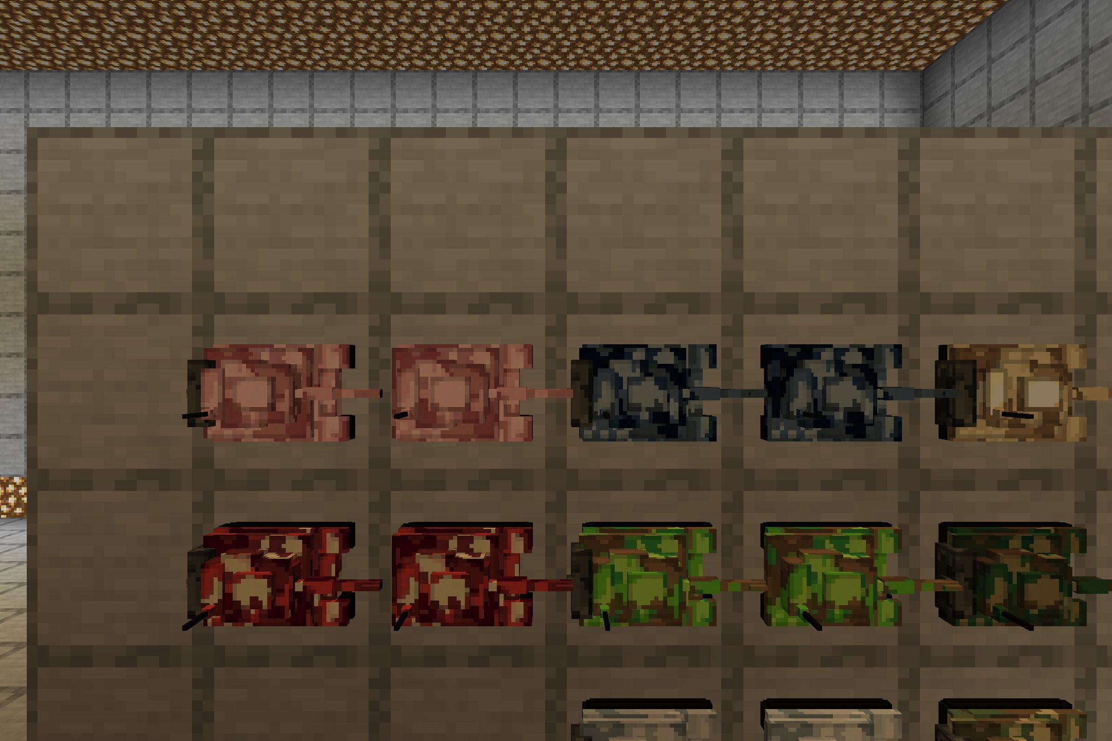 A display of several miniature tanks with different camouflage patterns on wood