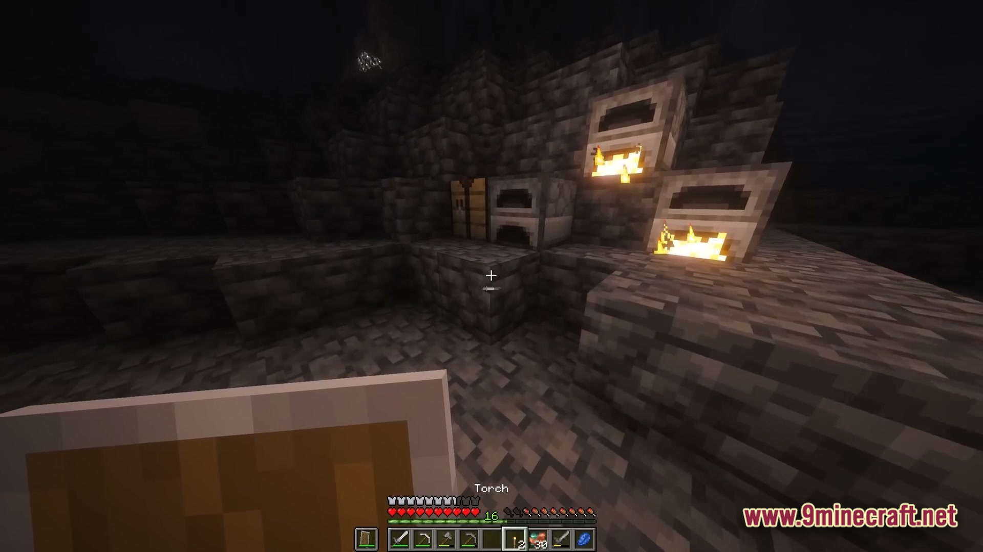 The Stalker Recreation Modpack (1.20.1) – Survive Craft Guns Hunt Monsters 4 A first-person view of a player holding a shield near furnaces and a crafting table underground