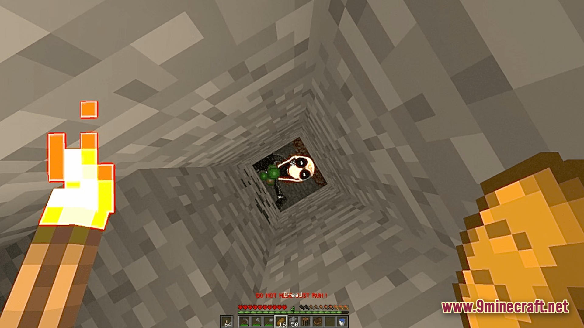 The Stalker Recreation Modpack (1.20.1) – Survive Craft Guns Hunt Monsters 9 A player looks down a stone shaft at a hostile creature while holding a torch