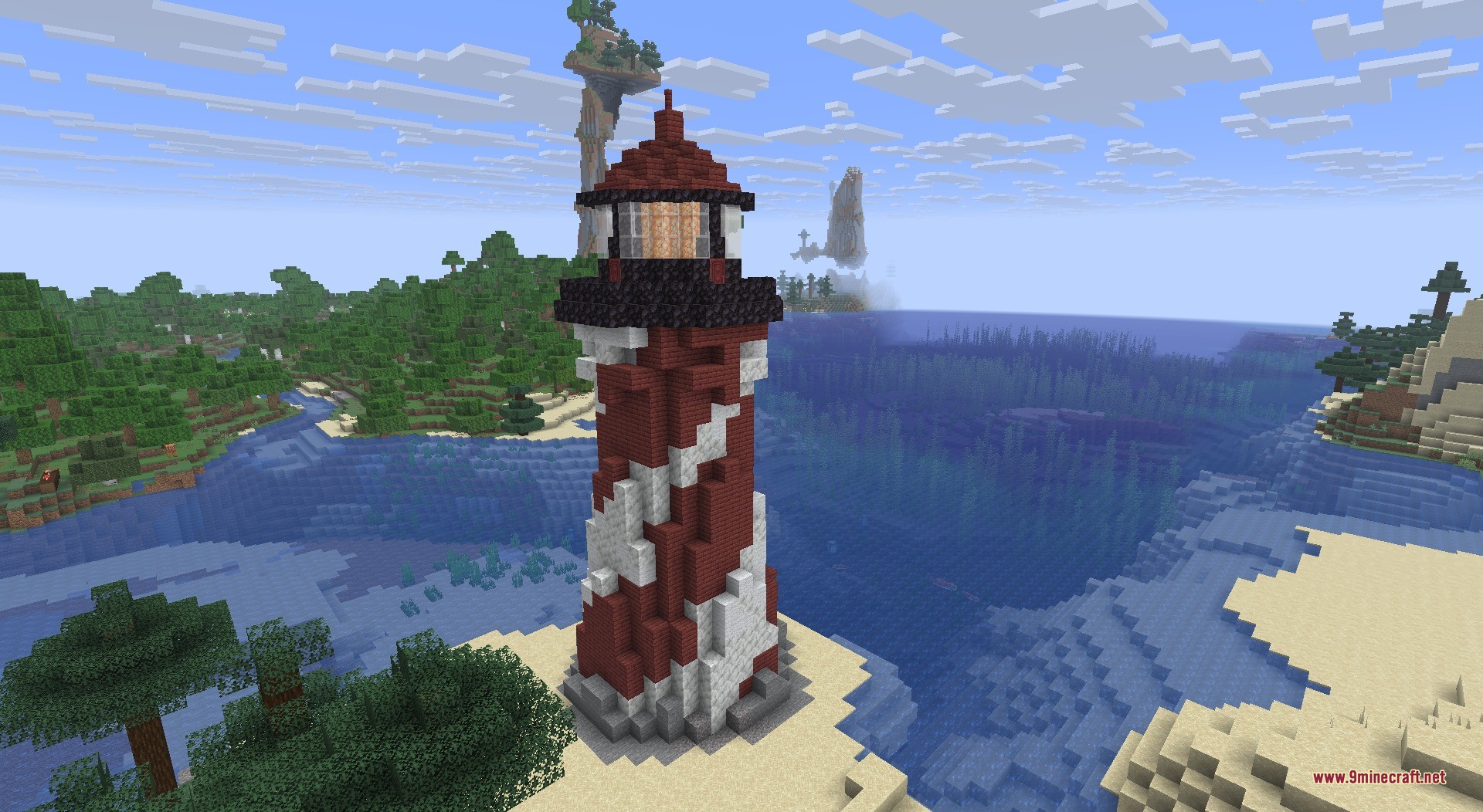 A red and white striped lighthouse on a sandy beach near the ocean
