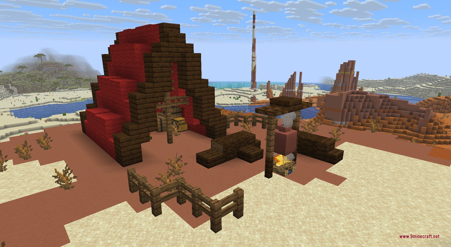 A campsite with a red tent and campfire in the badlands
