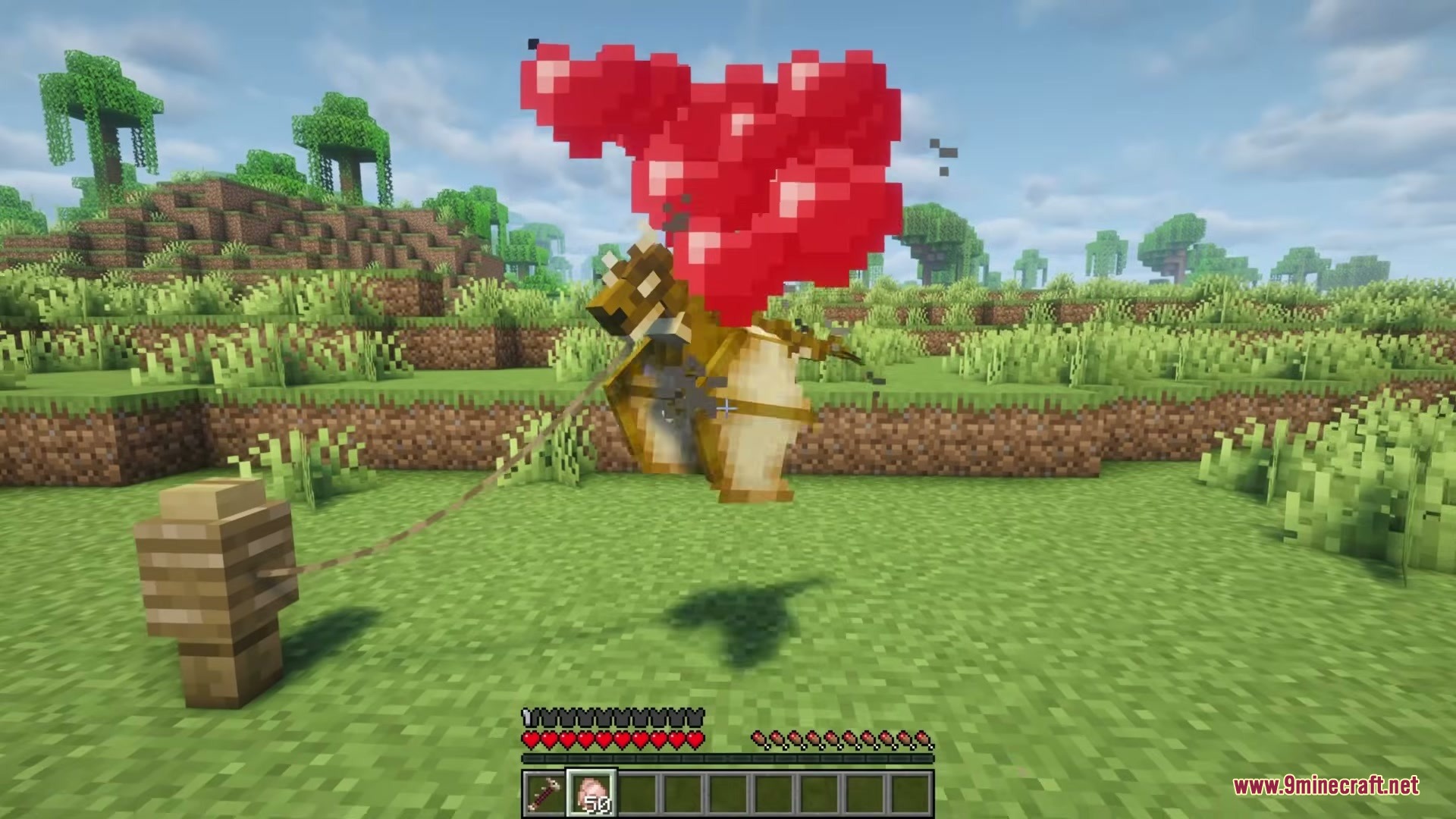 Tiny Dragons Reforged Mod (1.21.1, 1.20.1) – Hatch And Command Fire-Breathing 14 A tiny dragon tied to a fence post displays red heart particles