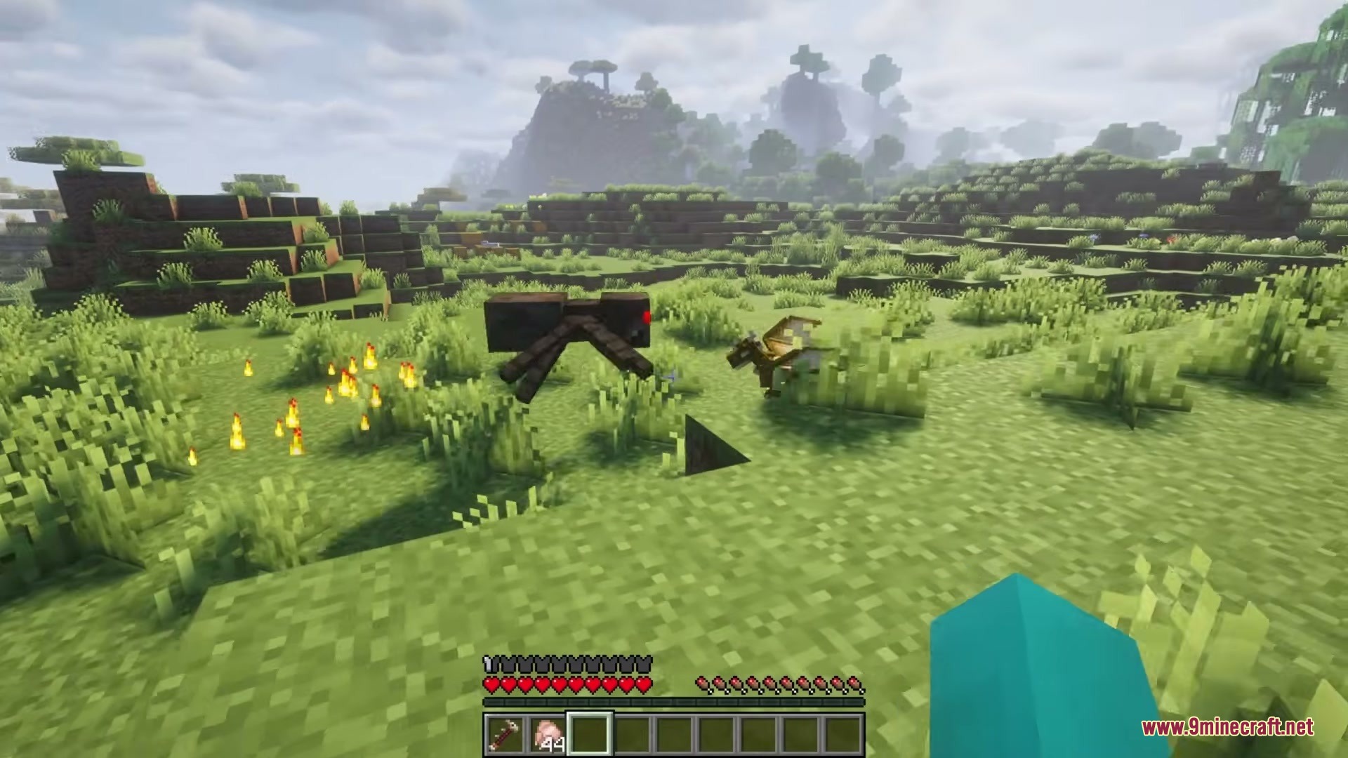 Tiny Dragons Reforged Mod (1.21.1, 1.20.1) – Hatch And Command Fire-Breathing 19 A tiny dragon fighting a spider while fire burns on the ground