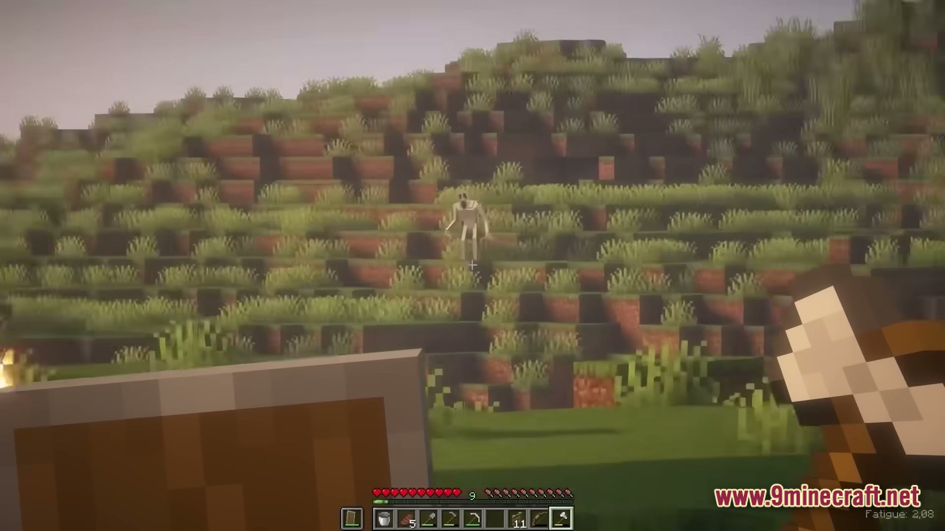 True Horror Modpack (1.20.1) – Survive Terrifying Monsters 3 A player holds a shield and axe while a tall, pale creature stands on a grassy hillside