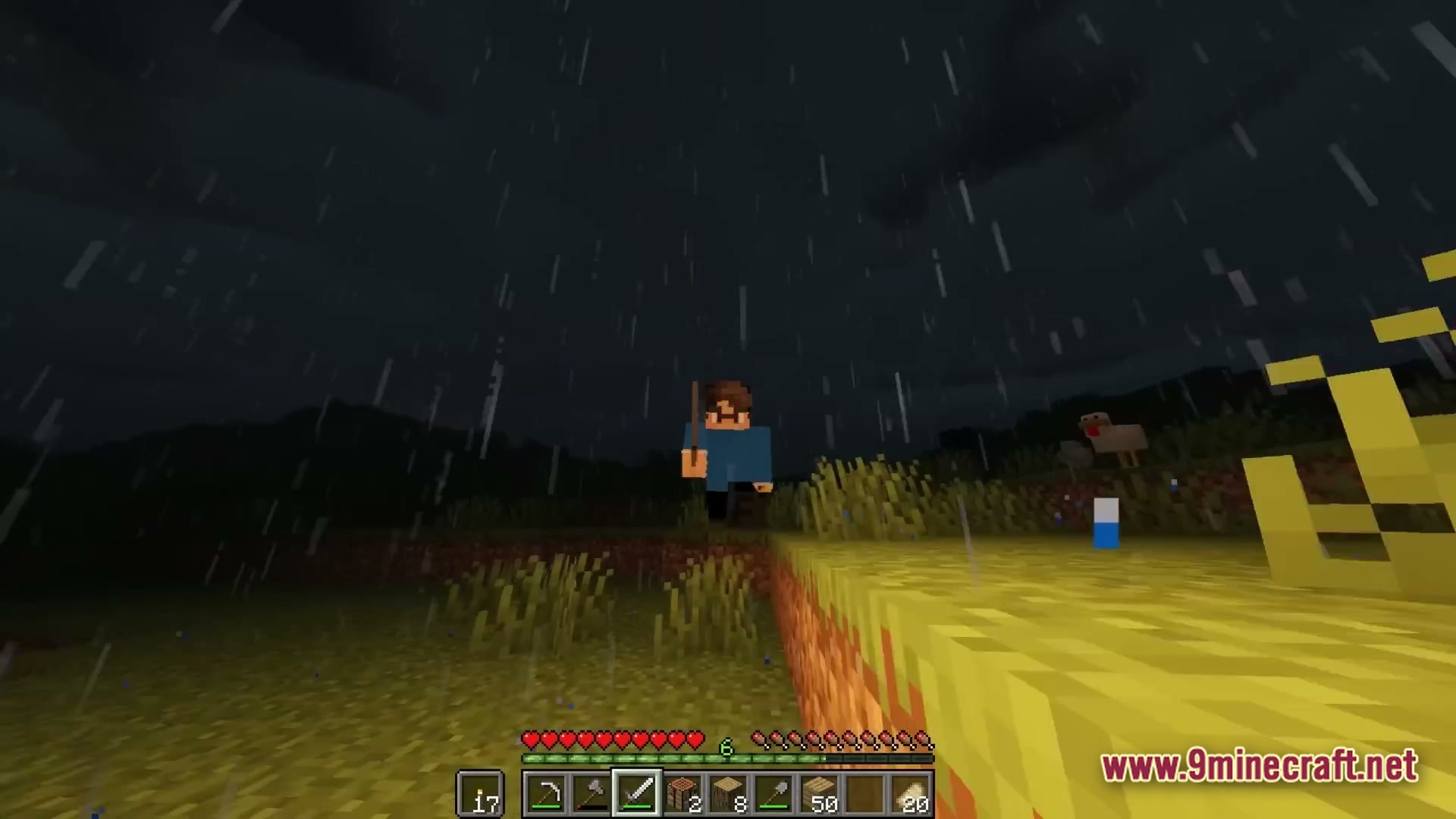A player character stands in a grassy field during a dark rainstorm at night