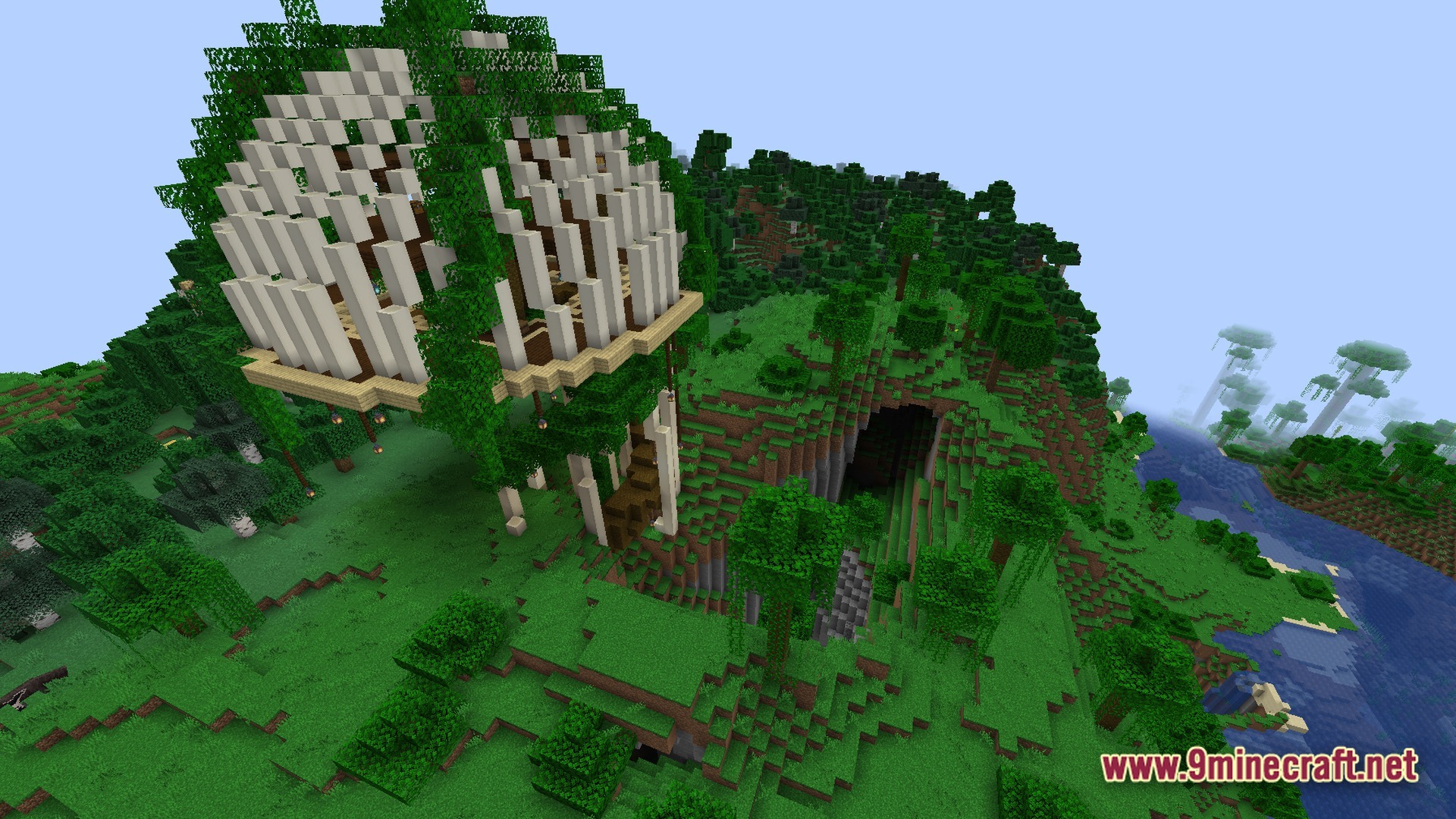 A large bone-ribbed structure covered in vines sits atop a forested hill overlooking a cave entrance