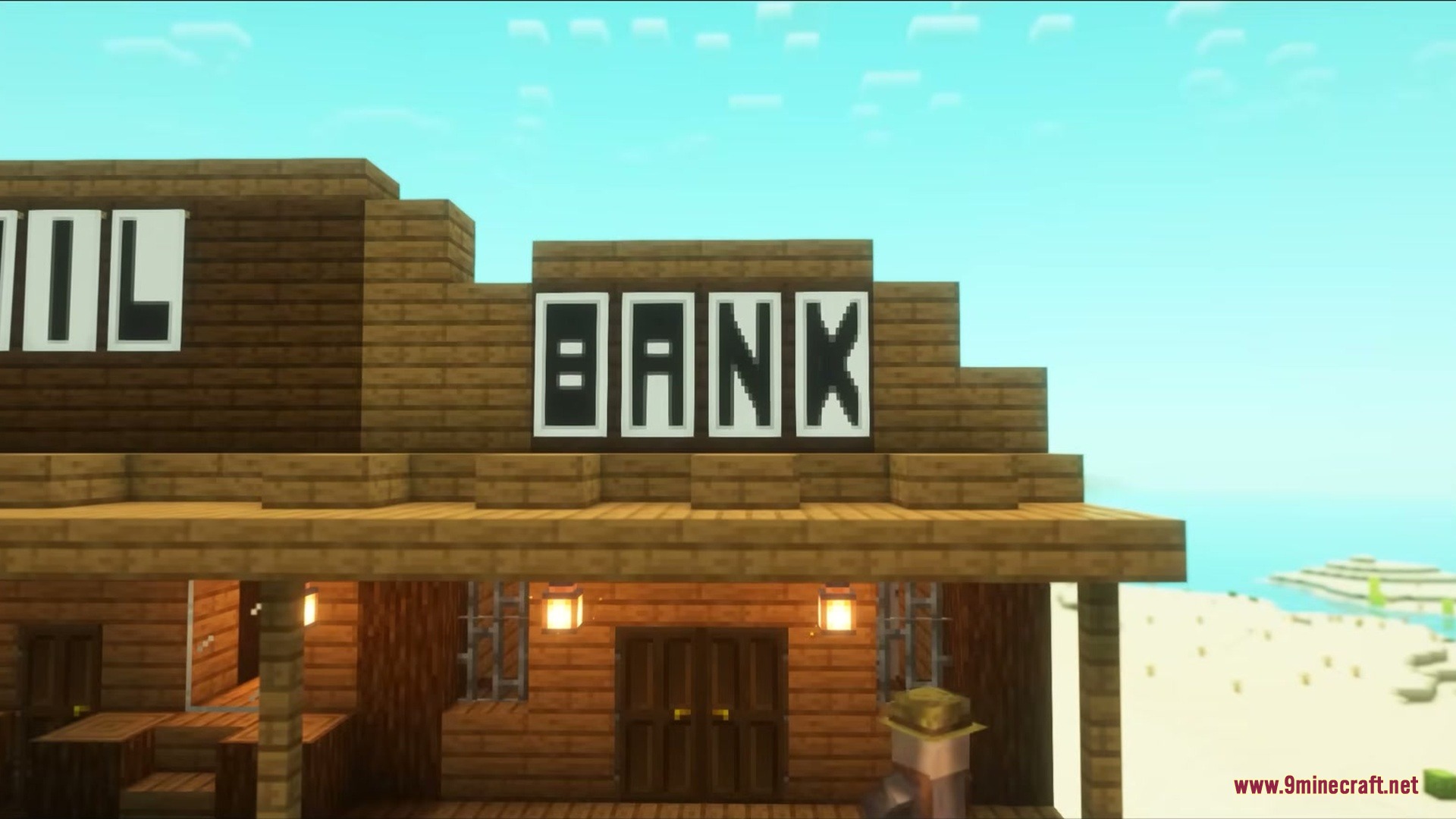 Wild West Structures Mod (1.21.8, 1.20.1) – Turn Dry Badlands Into Lively 5 A wooden bank building stands in a desert settlement under a clear sky