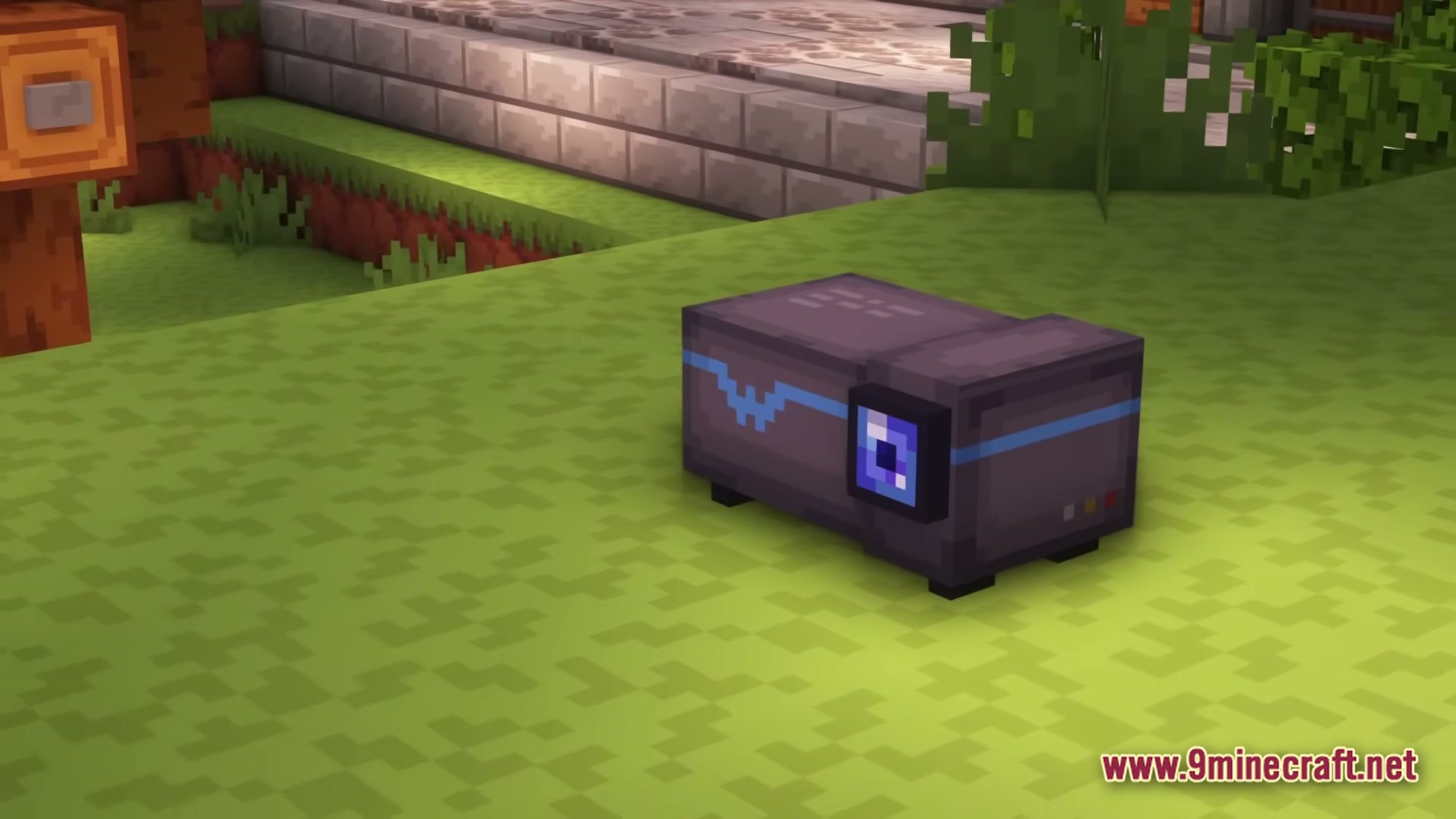 A small grey machine with a blue lens sits on a grassy minecraft landscape