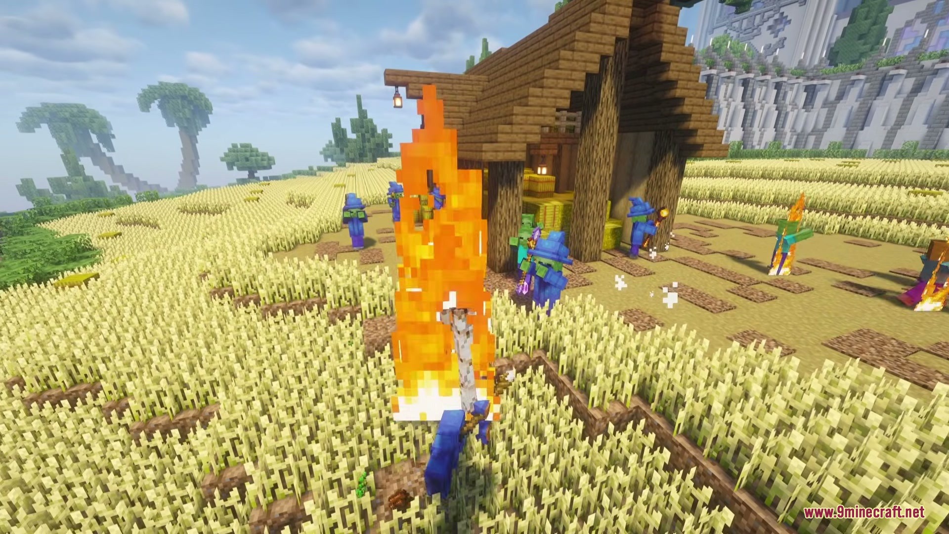 Wizard Mobs Mod (1.21.1) – Survive Magic Attacks From Spellcasting Undead 2 Zombie wizards in blue robes standing around a fire in a wheat field
