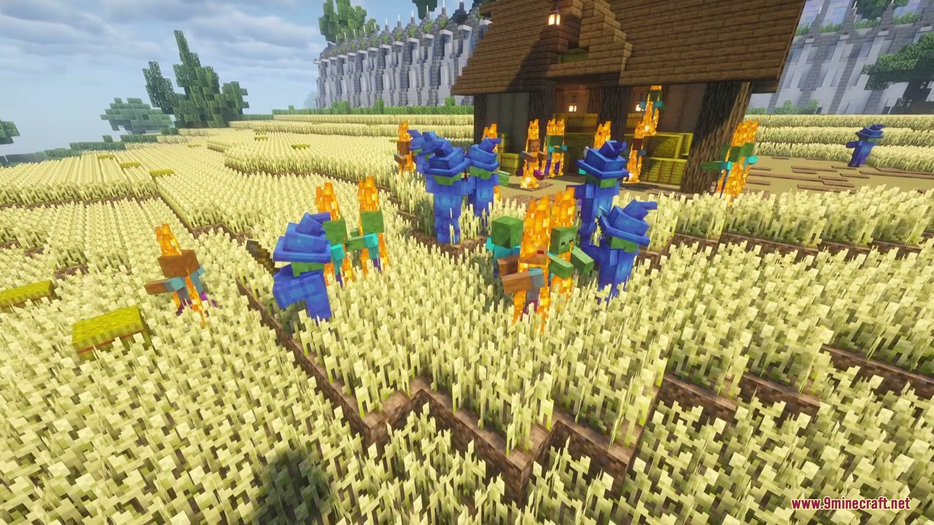 Wizard Mobs Mod (1.21.1) – Survive Magic Attacks From Spellcasting Undead 10 Zombies wearing blue wizard robes and hats burning in a wheat field