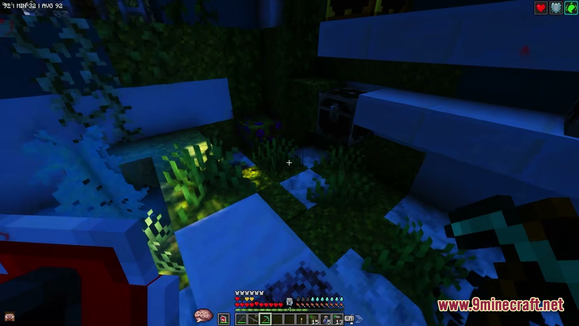 Zombiemania A Modern Zombie Apocalypse Modpack (1.20.1) – Survive The Ultimate Undead Wasteland 4 A first-person view of a player holding a pickaxe in a dark, overgrown underground structure
