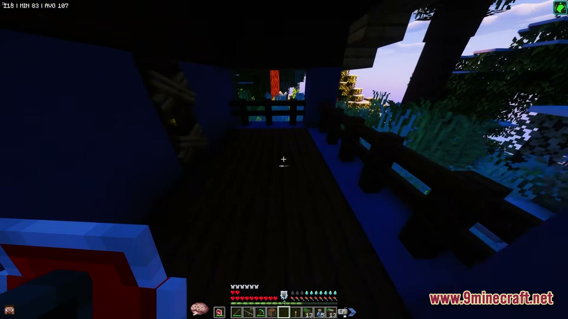 Zombiemania A Modern Zombie Apocalypse Modpack (1.20.1) – Survive The Ultimate Undead Wasteland 6 A player stands on a dark wooden balcony overlooking a dense forest at dusk